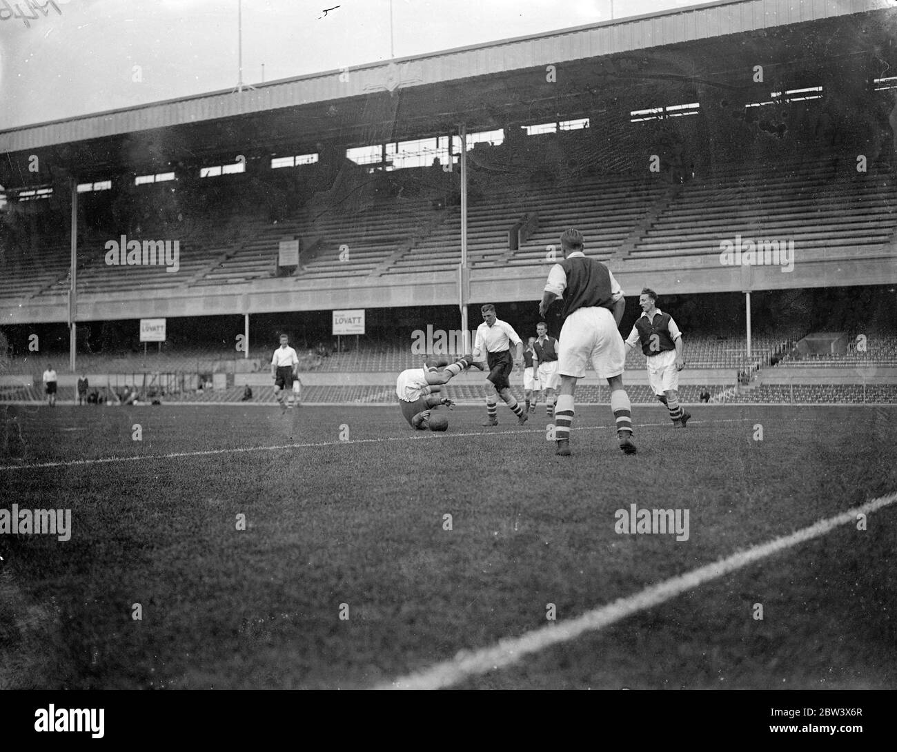 He does it on his heal ! . Reds met Whites in an Arsenal trial match at Highbury . Photo shows , Alex Wilson the ' reds ' goalkeeper , gives a ' gymnastic display ' when making a save . 22 August 1936 Original caption from negative Stock Photo