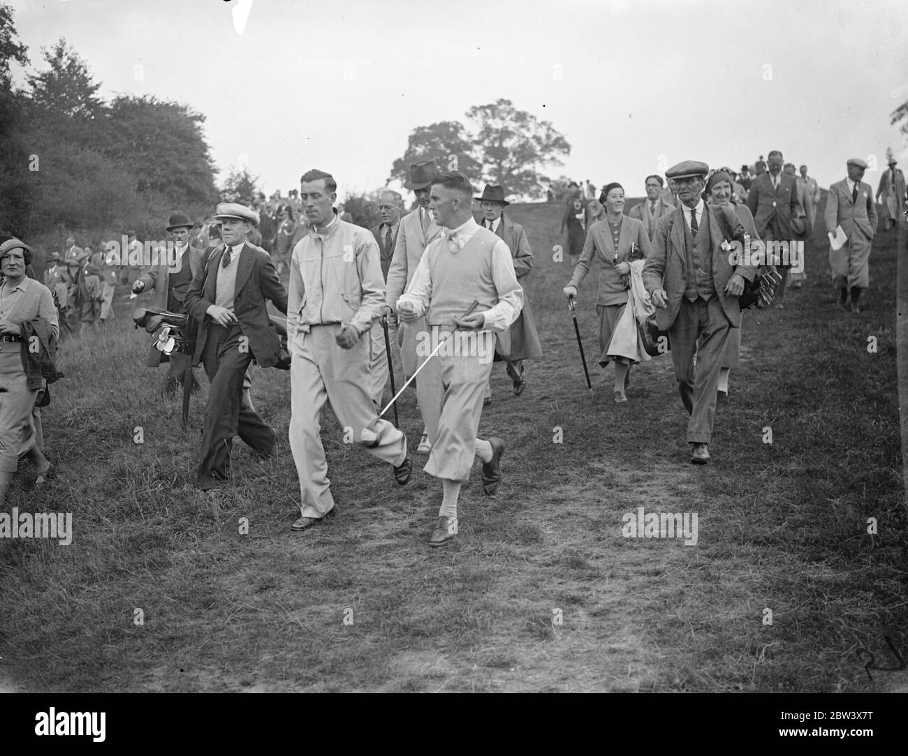 American competitor in big professional golf tournament . Leading golfers are competing in the professional matchplay championships worth Â£1250 at Oxhey , Herts . Photo shows , A H Pagden of Sundridge Park, last year's winner , left and his opponents K Williams ( Dinas Powis ) walking from the 3 tee . 15 September 1936 Stock Photo