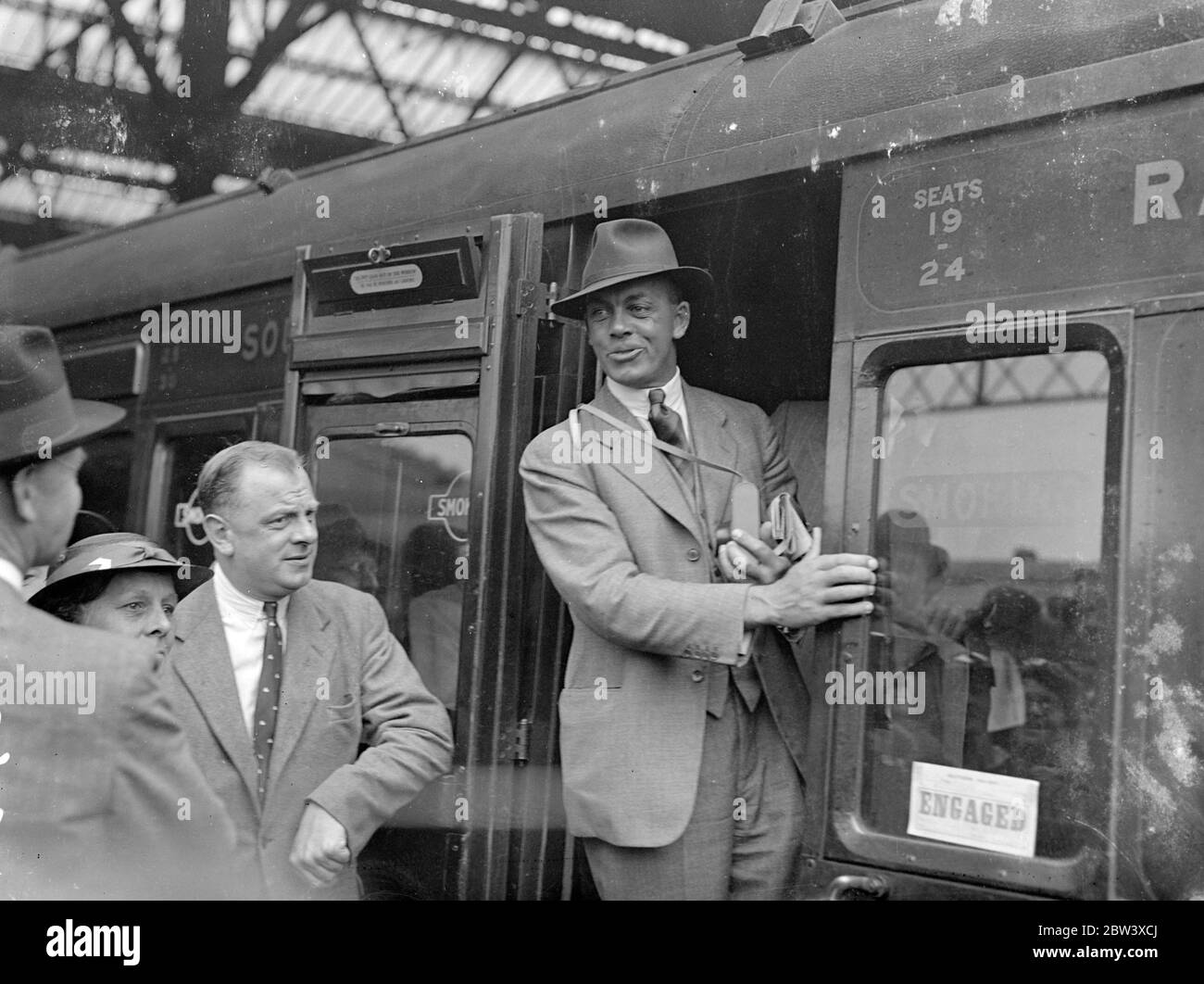 Hedley Verity beats influenza and leaves with test team for Australia . The M C C cricket team which is to oppose Australia in the Test matches left Waterloo Station for Southampton to embark . In the team was Hedley Verity , who is travelling despite the fact that he is recuperating from influenza . It was feared that he would not be fit enough to travel with the main party . Photo shows , Bob Wyatt in his carriage doorway at Waterloo . 12 September 1936 Stock Photo