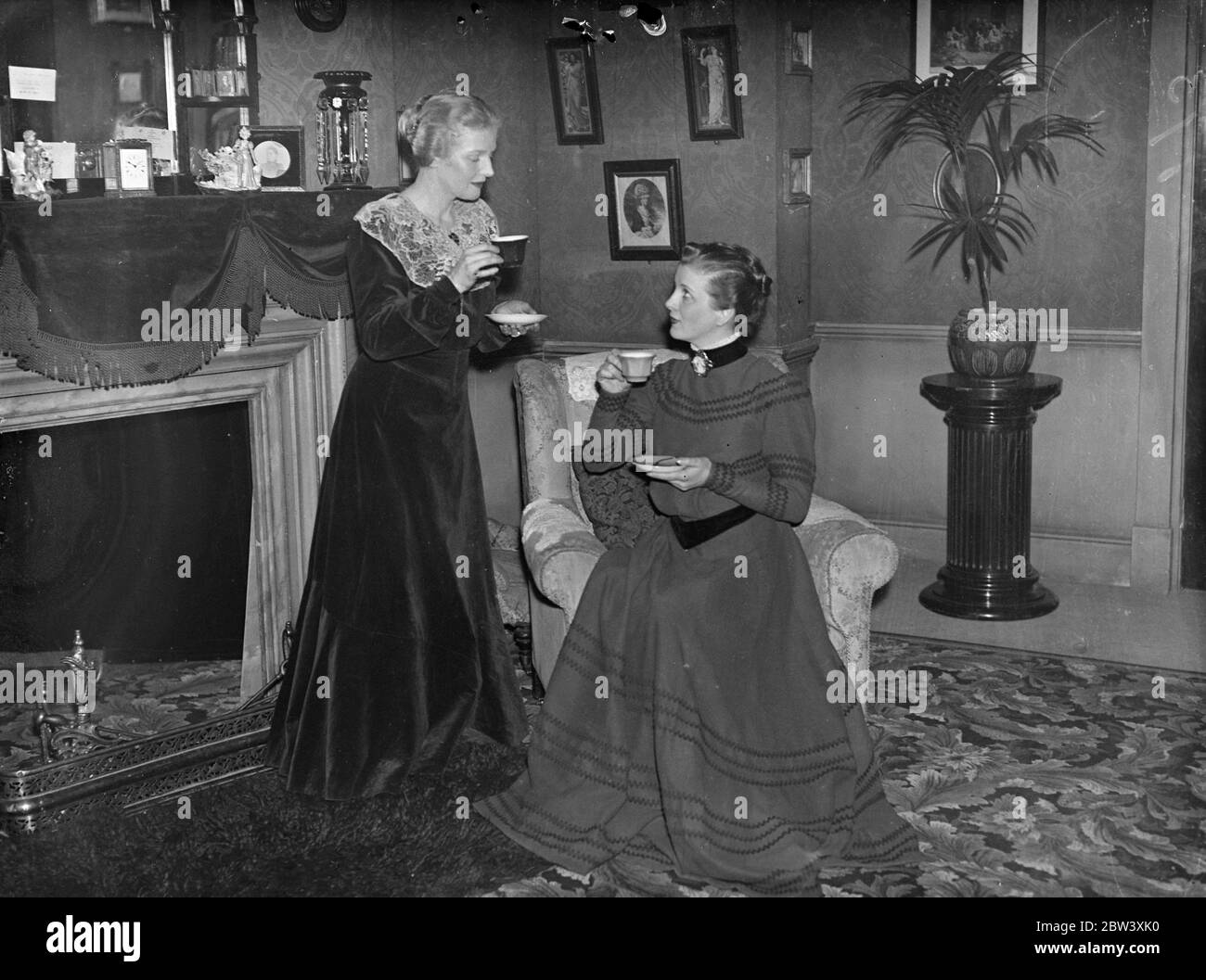The two candidas Ann Harding whishes successor good luck in Shaw Play. In the costume she wore for the part, Miss Ann Harding whishes good luck to hear successor, Miss Diana Wynyard, who is taking over the role of Candida in Bernard Shaw's play of that name at the Globe Theatre, Shaftesbury Avenue, London. Photo shows: Miss Ann Harding whishes her successor, Miss Diana Wynyard, good luck at the Globe Theatre. Both are wearing Candida's costume. 30 March 1937 Stock Photo