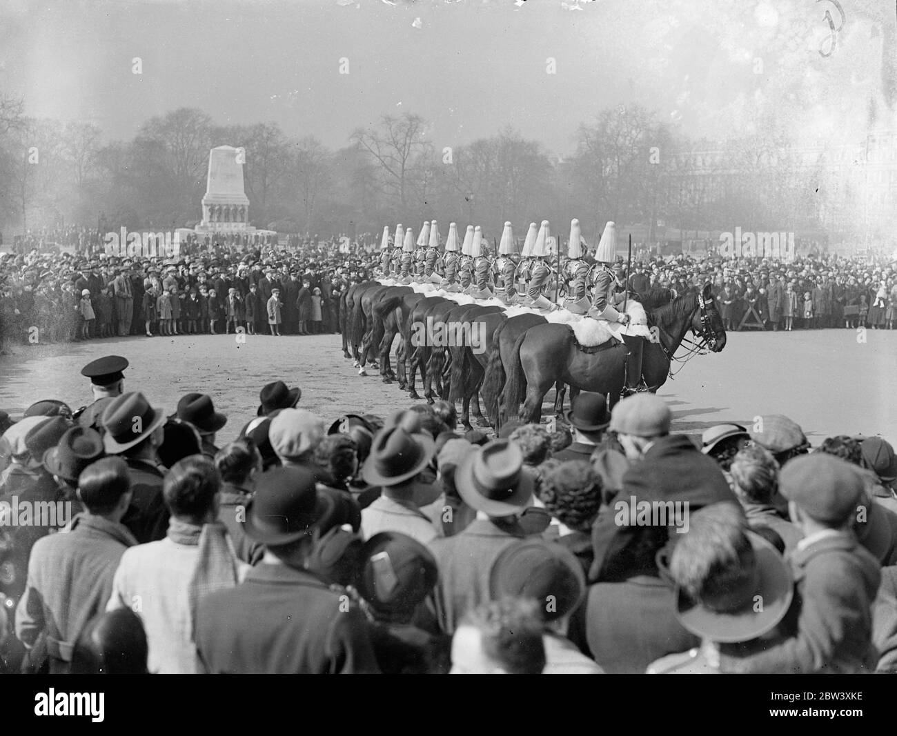 Large Easter Monday crowds watched the Changing of the Guard at the Horse Guards. The ceremony took place on the parade ground because Coronation stands now occupy the courtyard where it usually takes place. Photo shows: the enormous crowd watching the guard change on the Horse Guards parade ground. 29 March 1937 Stock Photo
