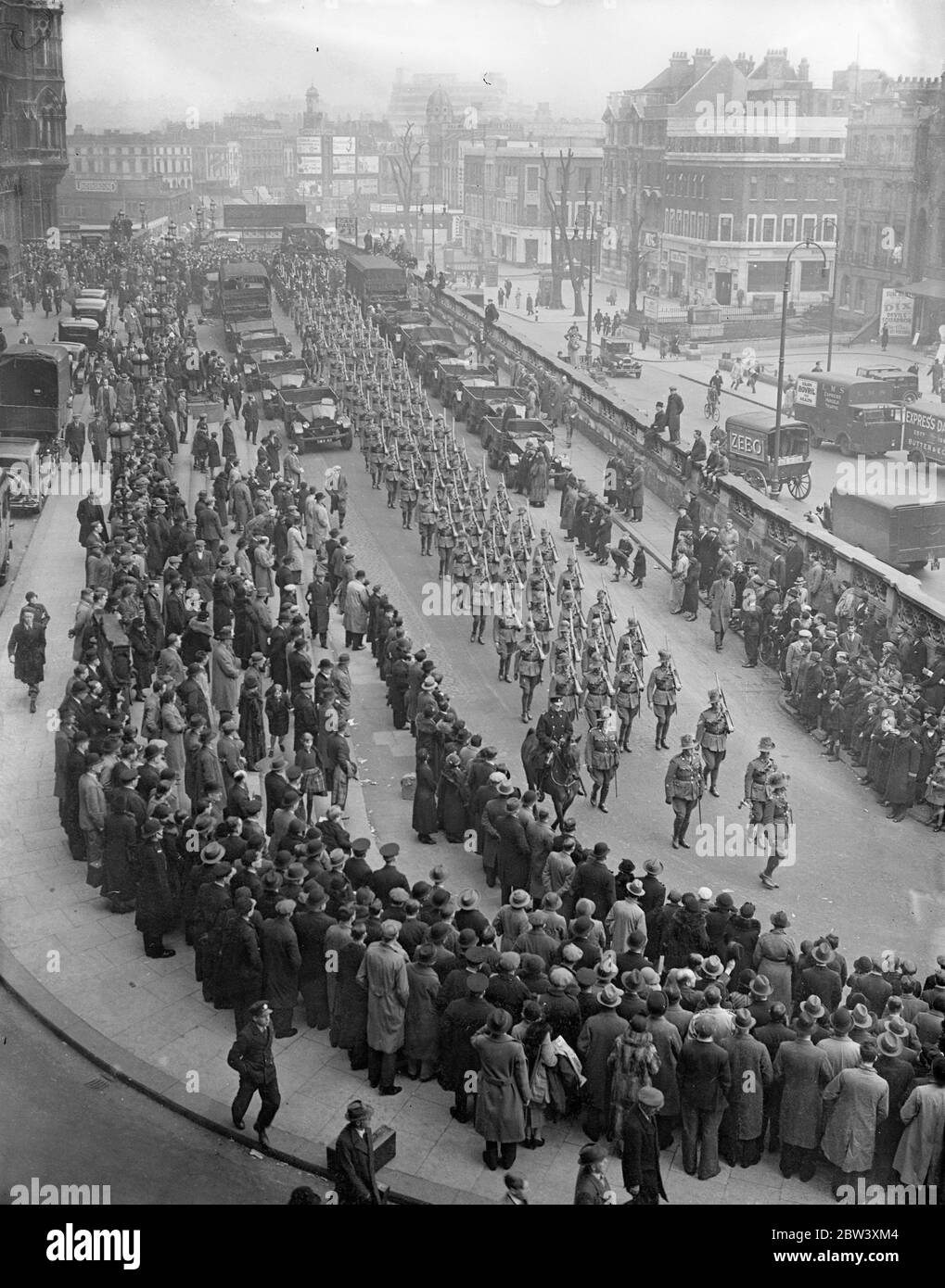 Wearing their familiar slouch hats, the first batch of Australian troops who will represent the Australian services at the Coronation, march through London from St Pancras station to Wellington Barracks after their arrival of the board that Oronsay . Photo shows: a general view as the Australians led by the Guards band left St Pancreas through the large crowds which welcomed them. March 25th 1937 Stock Photo