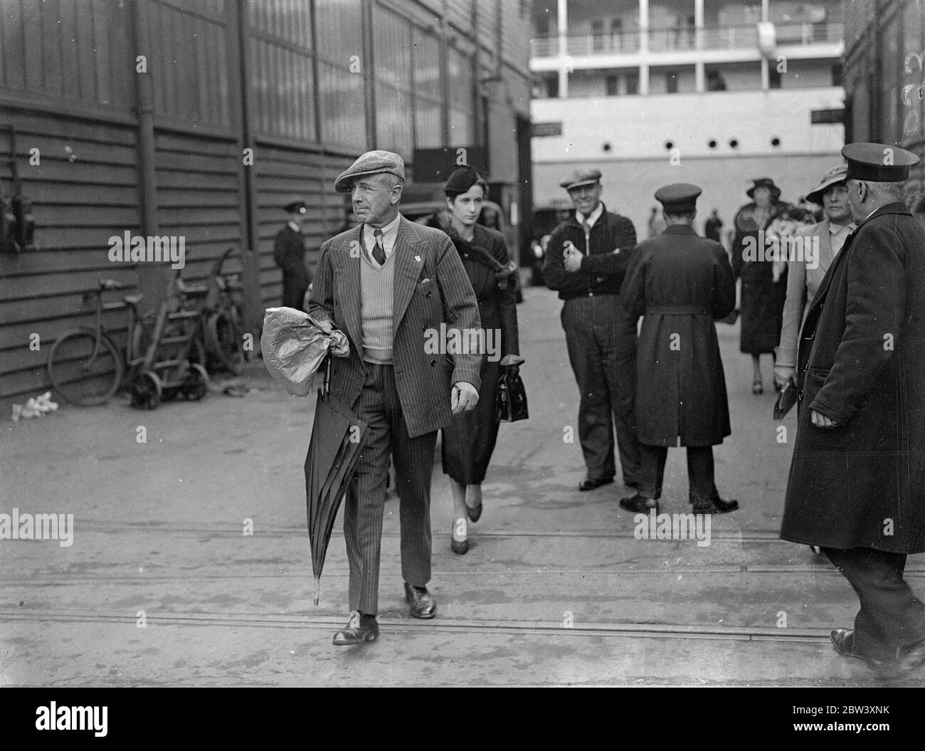 Earl Howe arrives home from South Africa with his wife . Earl Howe , the racing motorist , who was married in South Africa recently arrived at Southampton aboard the liner Athlone Castle with his wife from Cape Town . Earl Howe has been motor racing in South Africa . Photo shows , Earl Howe going ashore at Southampton followed by his wife . 19 March 1937 Stock Photo