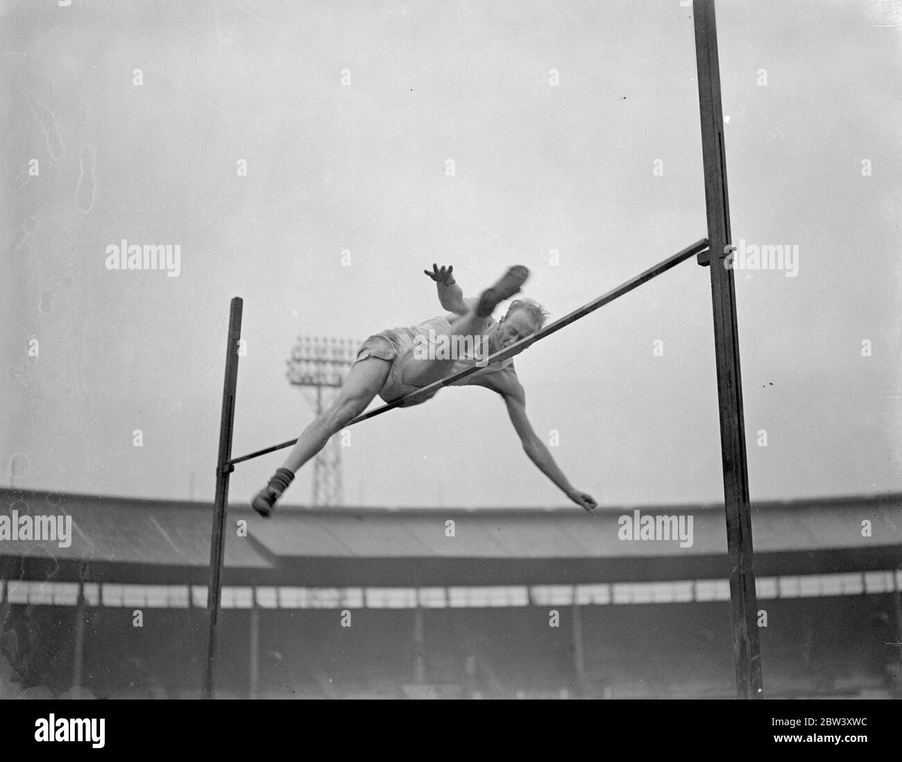 American high jumper practises at White City for Oxford Cambridge Sports . Oxford University athletes practised at the White City , London , for the Inter Varsity sports meeting with Cambridge to take place at the White City on March 20 . Photo shows , R C Hall , a 22 year old Californian from Harvard now reading economics at Oxford , practising the high jump at the White City . Hall ' s last outing at the White City was two years ago when he jumped for Harvard and Yale against the English Universities , winning with a jump of 5ft 10in . 12 March 1937 Stock Photo