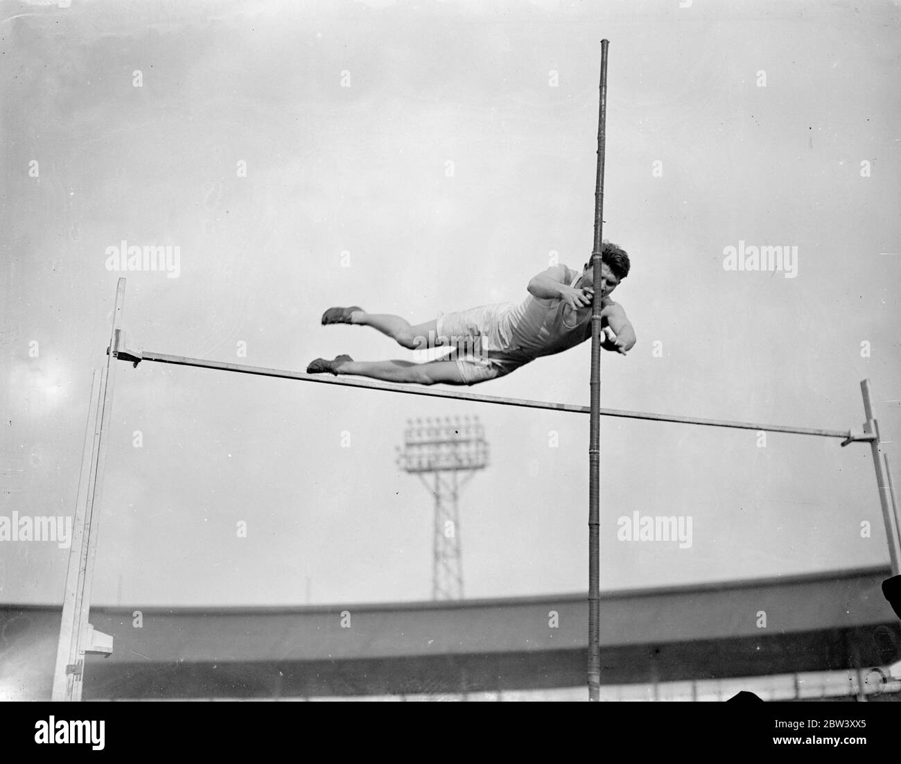 American athlete practises at White City for meeting with Cambridge . Oxford University athletes practised at the White City , London , for the Inter Varsity sports meeting with Cambridge to take place at the White City on March 20 . Photo shows , R R Ferguson University of South California and Lincoln ( Oxford ) practising for the pole vault . 12 March 1937 Stock Photo