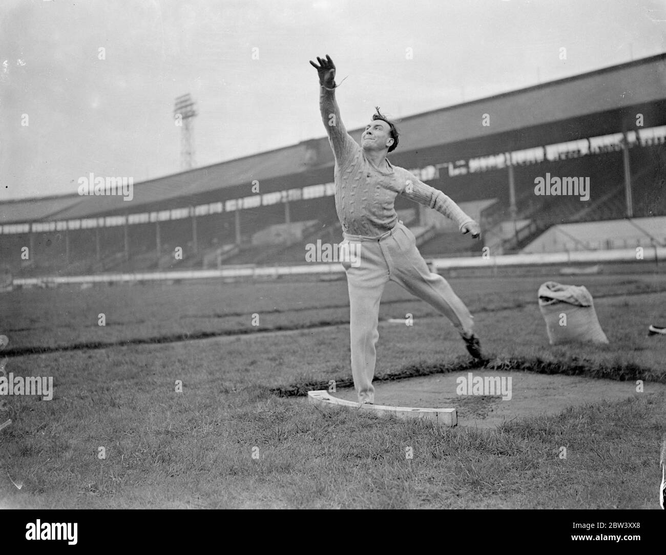Oxford university athlete practises at White City for meeting with Cambridge . Oxford University athletes practised at the White City , London , for the Inter Varsity sports meeting with Cambridge to take place at the White City on March 20 . Photo shows , D G Brown practising putting the weight at the White City . 12 March 1937 Stock Photo