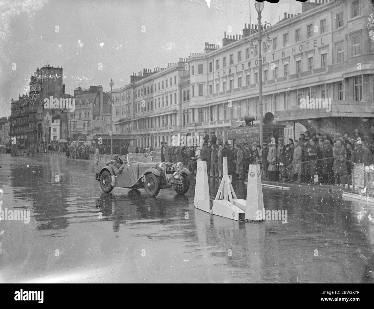 Rough weather greets RAC Rally Competitors at Hastings . After spending two days and nights on a gruelling thousand miles course competitors in the RAC , Rally arrived at Hastings , the finishing point . Photo shows , speed and reversing tests in progress on the sea swept promenade at Hastings . 11 March 1937 Stock Photo