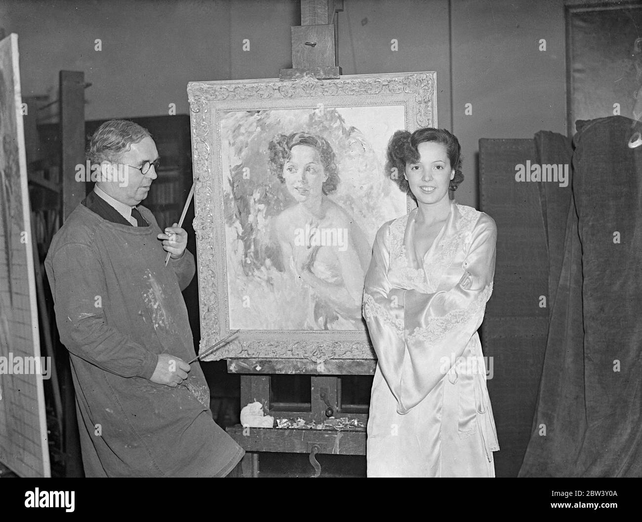 Jessie Matthew ' s portrait for Royal Academy . A portrait of Miss Jessie Matthews , the stage and film actress is being painted by Mr T C Dugdale , ARA , at his London studios , for entry in this year ' s Royal Academy . The actress is pictured against a woodland background . Photo shows , Miss Jessie Matthews with her portrait on which Mr TC Dugdale is working at his London studios . 10 March 1937 Stock Photo