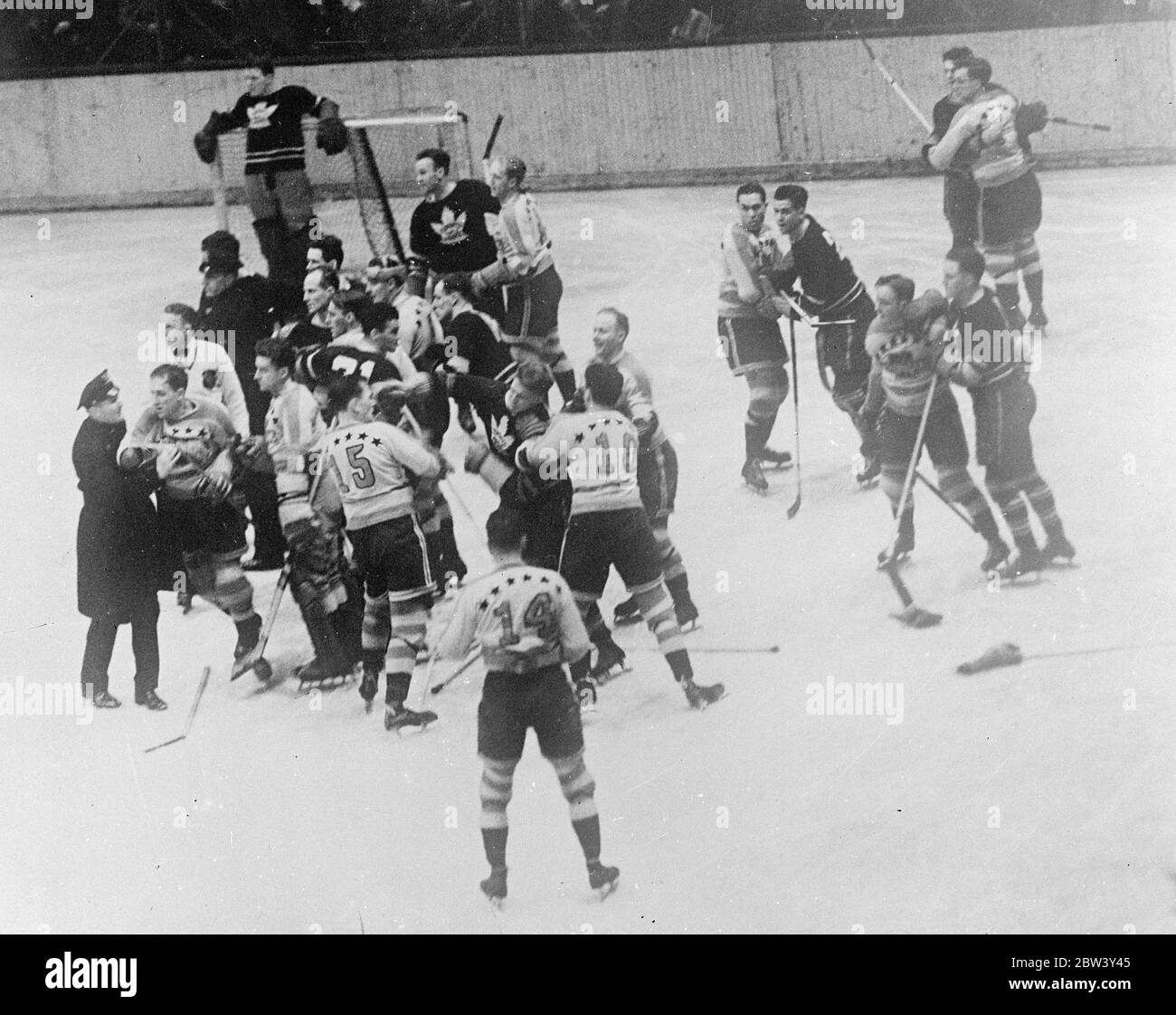 New York Ice hockey match ends in free fight , Police intervene . A free fight , in which a squad of police were forced to intervene to restore order , marked the ice hockey match between the New York Americas , and Toronto Maple Leafs at the Madison Square Gardens , new York . The Americans defeated the Maple Leafs 3 - 1 . Photo shows , the fight between the two teams on the ice at Madison Square Gardens . Jenkins ( 10 ) of the Americans is holding one of the Toronto players as he strikes at Emms ( 15 ) , also of the Americans . Left is Schriner ( Americans ) being held by a policeman . 9 Mar Stock Photo