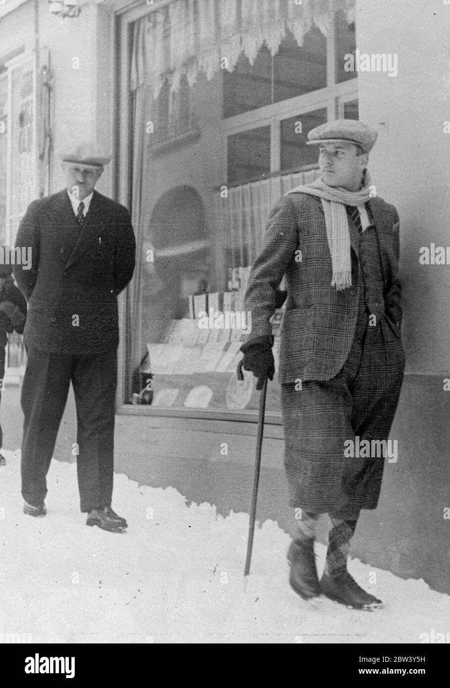 Young King of Egypt spends winter sports Holiday at St Moritz . The young King Farouk of Egypt , accompanied by his mother and sisters , is spending a winter sports holiday at St Moritz , Switzerland , before travelling to England for the Coronation . Photo shows , King Farouk , in plus fours , walking through the snow at St Moritz . 9 March 1937 Stock Photo