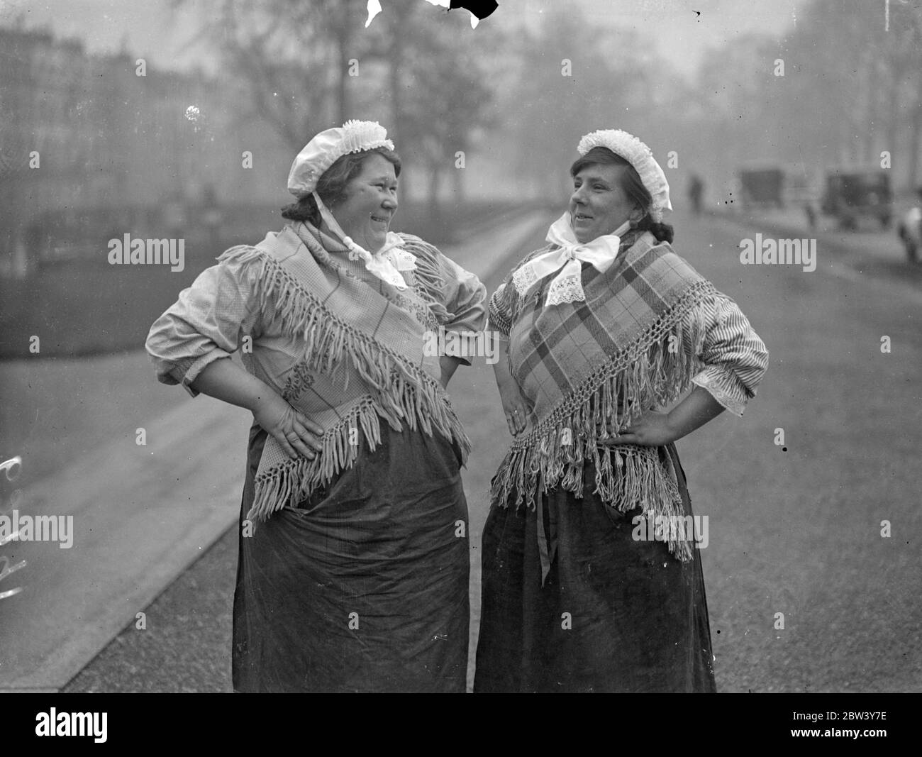 Belgian fisherfolk in London for Albert Hall reunion . A group of Belgian fisher folk in national costume are attending the Polytechnic Tours Reunion at the Royal Royal Albert Hall , London . This is their first visit to London . Photo shows , two typical women members of the party photographed in London . 6 March 1937 Stock Photo