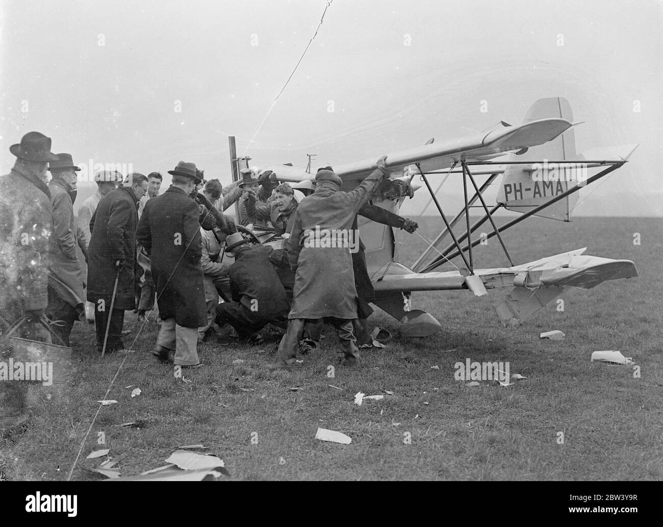 Fool-proof flights plane crashes at Gravesend Demonstration - pilot trapped in wreckage. The first demonstration in England of the Schelemusch, a Dutch light plane said to be full-proof, ended in a crash at Gravesend Aerodrome. The plane was piloted by Mr R. G. Doig who was injured. The machine was flying low and trying to make a sharp turn when it was caught by a gust of wind and completely wrecked. Mr Doig's leg was caught in the wreckage, the pilot having to wait until rescuers could extricate him. The Schelemusch, [de Schelde Scheldemusch] a singles-seater, is fitted with a 40 horsepower t Stock Photo