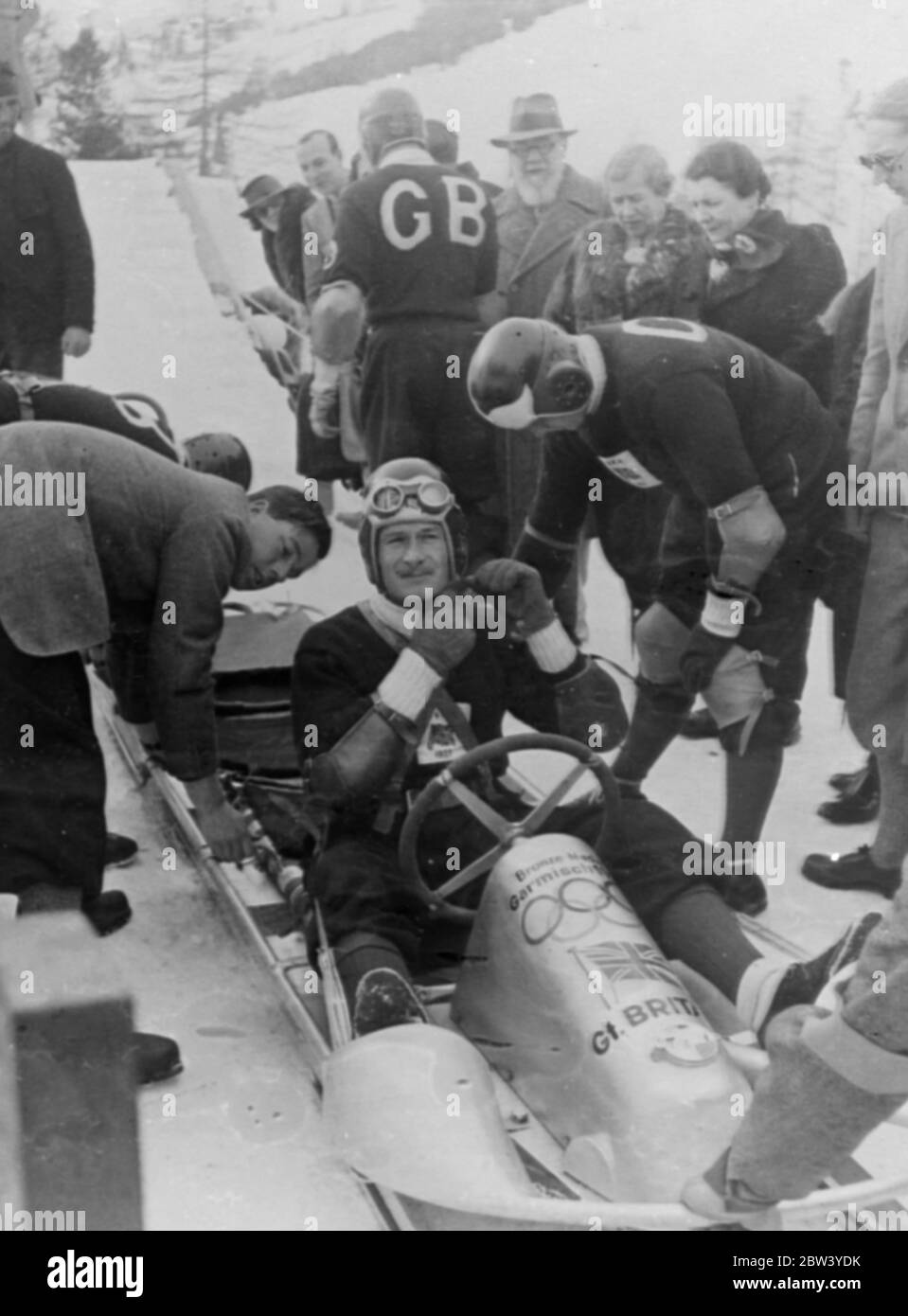 Britain wins world bobsleigh championship at St Moritz. Captain by F. J. McEvoy, the Olympics sleigher, the British team won the world four-man bobsleigh championship from Germany (second) and America at St Moritz. The team had an aggregate for four runs of 5 minutes 8.5 seconds. Photo shows: F. J. McEvoy and his team at the start of last run at St Moritz. 13 February 1937 Stock Photo