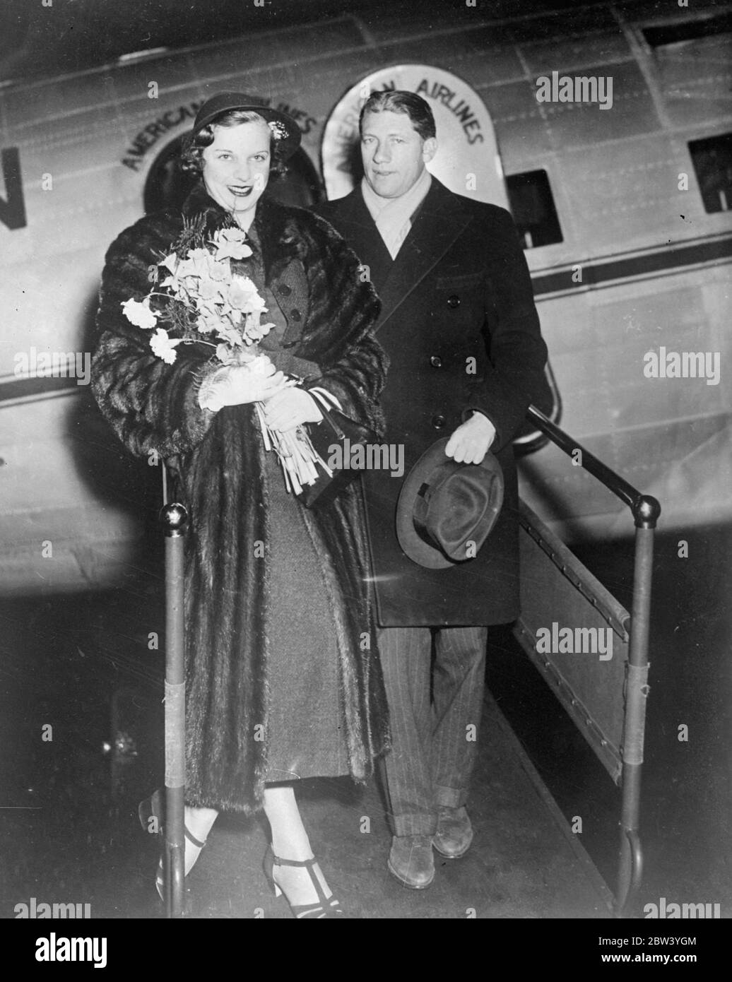 Hon Mrs Montagu Elopes to Mexico . Marries Broadway writer . The honorary Mrs Tanis Guinness Montagu photographed with her husband , Howard Dietz , the Broadway writer and publicity expert , on arrival at Newark , New Jersey , on our honeymoon flight after they had elopled and were married in Juarez , Mexico . The Hon Mrs Montagu recently cancelled at the last minute her arrangements to marry the Earl of Canavan . 27 January 1937 Stock Photo