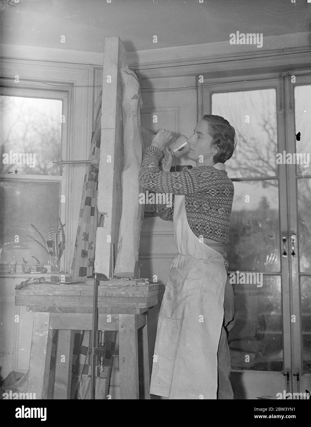 London woman designs 30 feet high window for British Pavilion at Paris exhibition. A 30 foot high window of sculptured glass, an entirely new process, with the Britannia motif to the design of Gertrude Hermes of London is incorporated in the British Pavilion now under construction in Paris for the great international exhibition of arts and industry which opens in May. The window faces Place d'Honneur of the exhibition. Photo shows: Gertrude Hermes, designer of the window for the British Pavilion at work in her London studio. 27 January 1937 Stock Photo