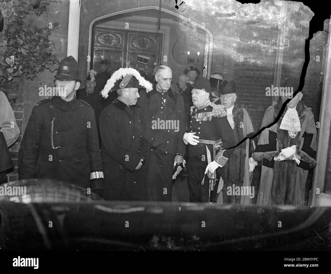Sir Herbert Samuel and Mr Winston Churchill at St James's Palace - new King takes oath. Photo shows: (left to right) Sir Herbert Samuel, Major Fitzroy, speaker of the House of Commons, and Mr Winston Churchill chatting as they left St James's Palace after King George VI has been sworn in before the Accession Council 12 December 1936 Stock Photo