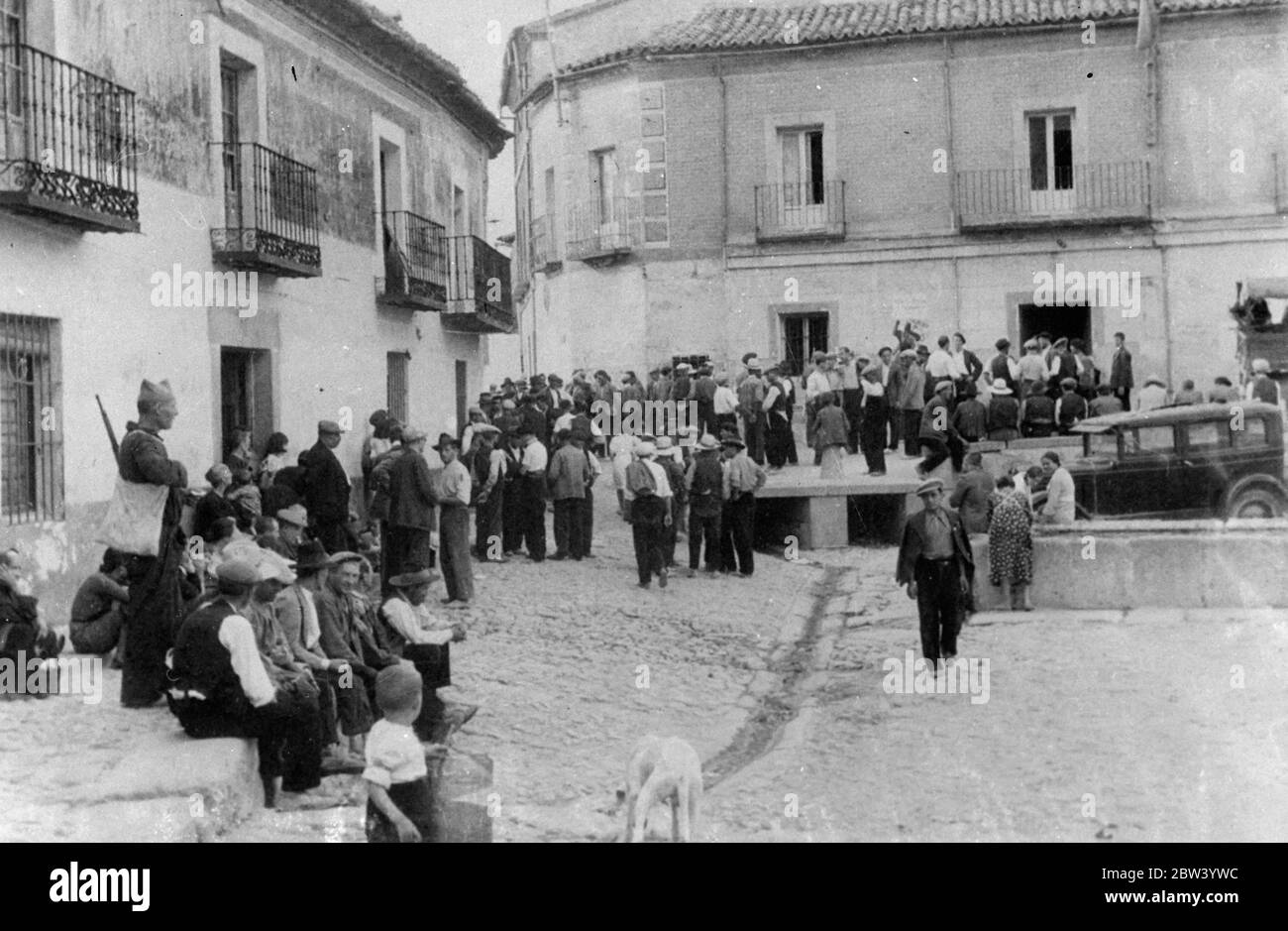 Loyalists occupy a recaptured village south of Madrid. A number of villages north of Madrid are again in government hands as result of successful counter-attacks made by strong forces of militiamen engaged in the defence of the capital against the rebels. Despite the recovery of lost ground by the loyalists, the insurgents say they are still advancing. Photo shows: government supporters occupying the main square of the recaptured village south of Madrid. 4 November 1936 Stock Photo