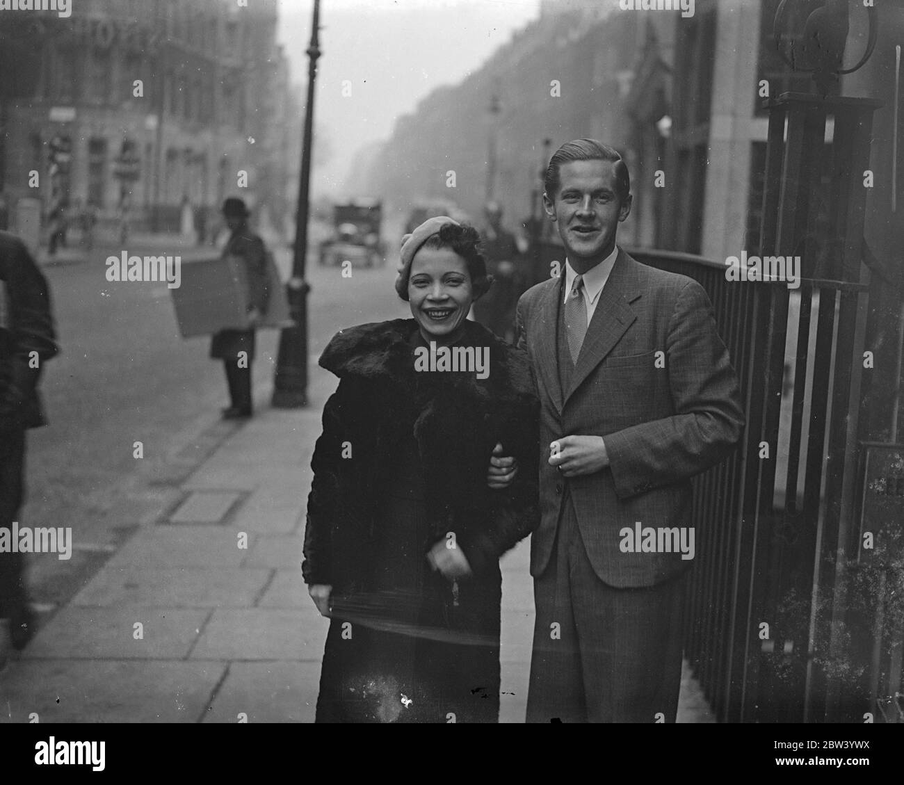 Trombonist and girl variety artist married at the London Register Office. Miss Frankie McCarthy, an American variety artiste, and Mr Bruce Campbell, a Canadian trombone player in Jack Harris's Band, were married at Bloomsbury Register Office,, London. Photo shows: the bride and groom after the wedding. 5 November 1936 Stock Photo