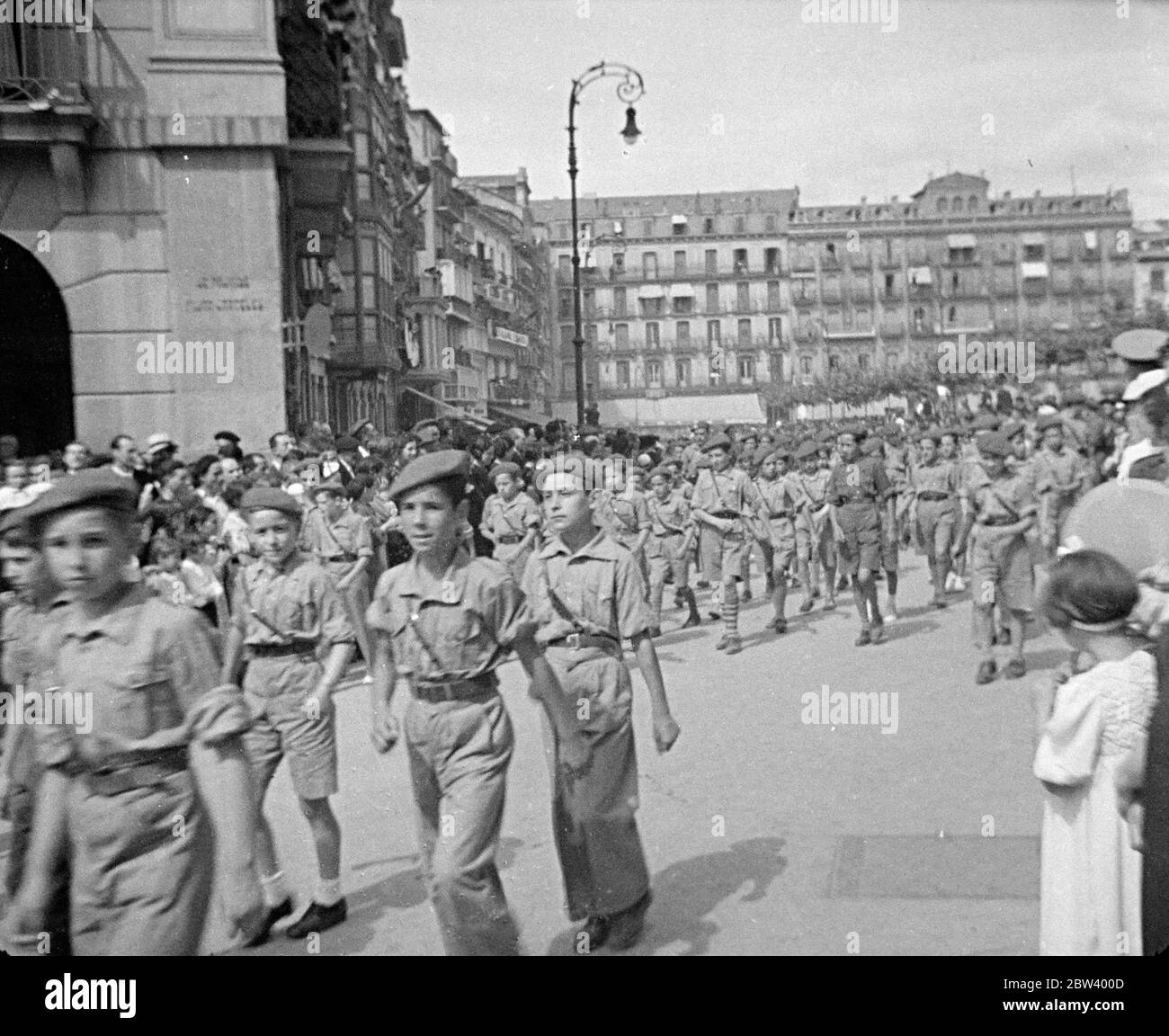 The arrival of the Nationalist troops in San SebastiÃ¡n / Donostia. Photo shows: Boys in uniform parading through the city alongside the Nationalists troops . ? September 1936 Stock Photo