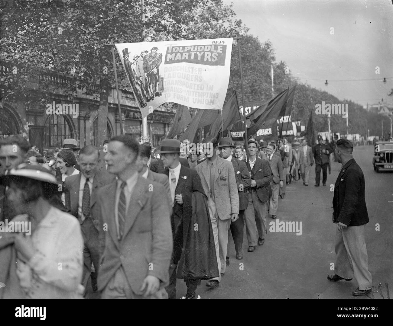 English history in parade through London's streets . Hundreds of banners representing English history from Magna Carta to the general strike were carried by communists who marched from Victoria Embankment to Hyde Park . Photo shows , a ' Tolpuddle Martyrs ' carried in procession . 20 September 1936 Stock Photo