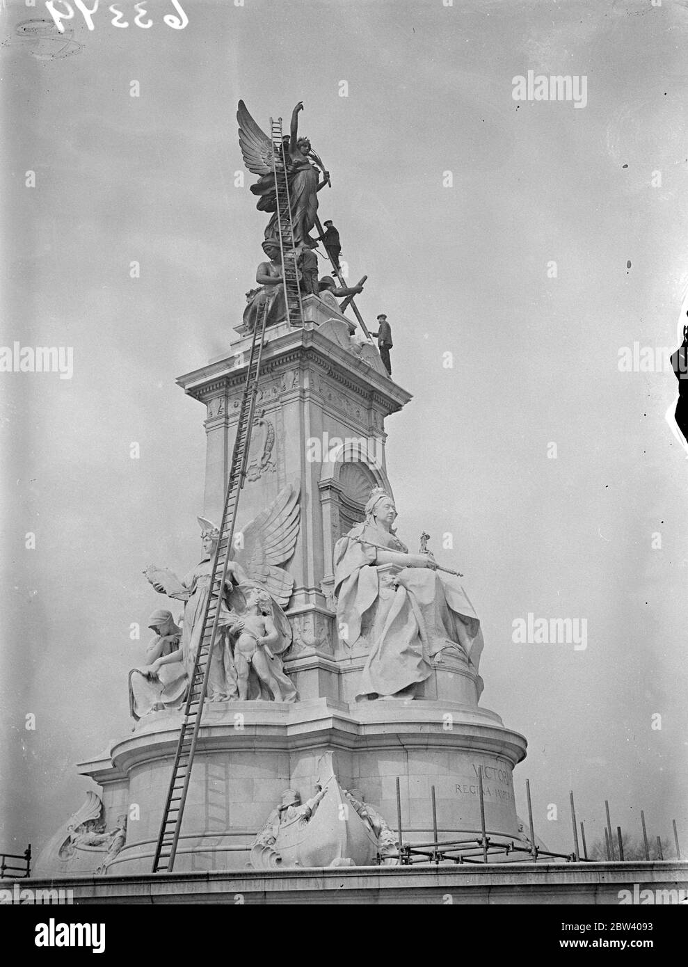 Victoria Memorial being cleaned for Coronation . The Victoria Memorial outside Buckingham Palace is being cleaned in preparation for the Coronation . Photo shows cleaning the Victoria Memorial . 12 April 1937 Stock Photo