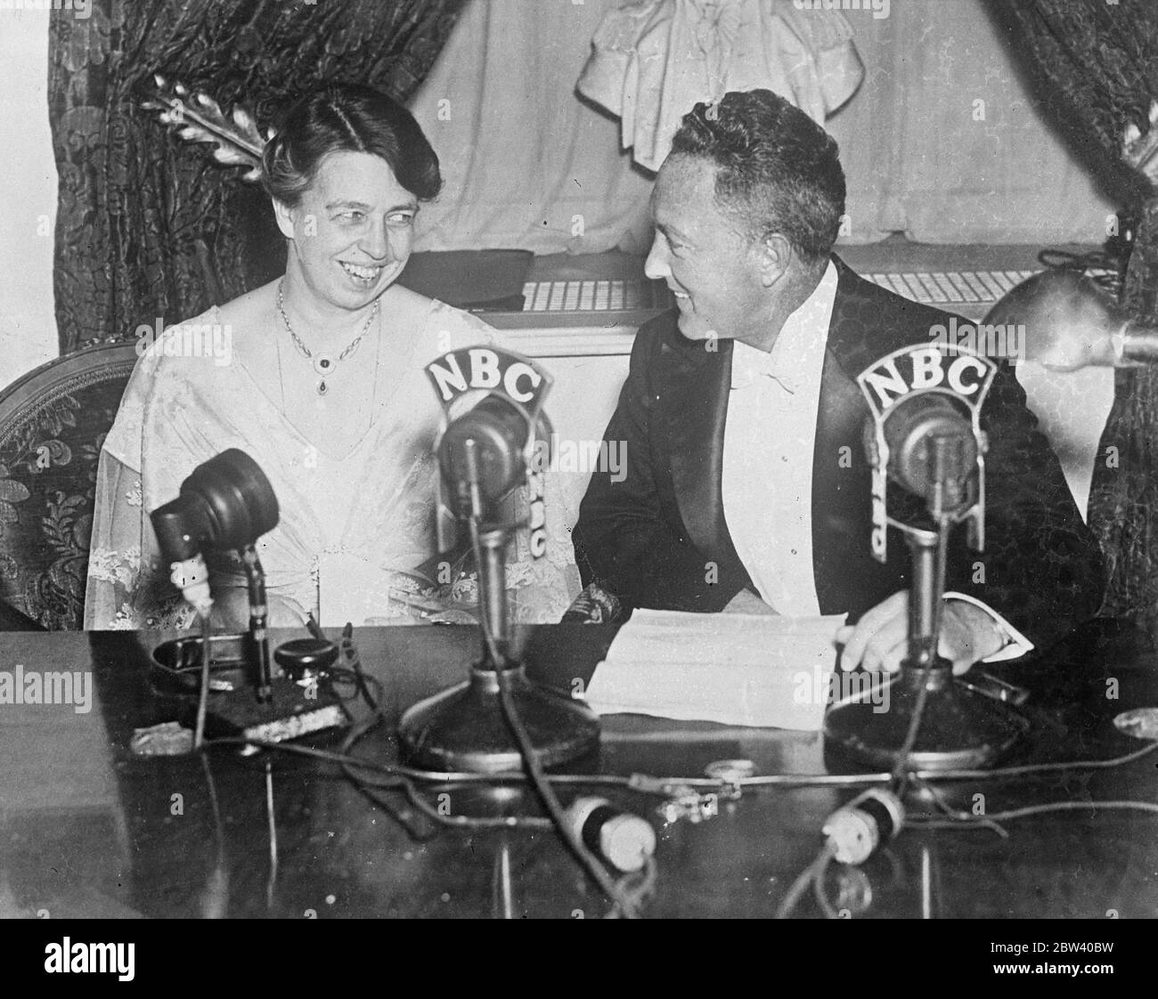 Eleanor Roosevelt and Rear Admiral Byrd deliver a radio peace message on 20th anniversary of America ' s entry into war . Mrs Franklin D Roosevelt , wife of the American president , and rear Adml Richard E Byrd , the polar explorer , delivered a broadcast peace message from the White House . Washington , on the 20th anniversary of America's entry into the Great War / WW1 Photo shows , Miss Roosevelt and rear Adml Byrd at the microphones as they delivered their peace message . 12 April 1937 Stock Photo