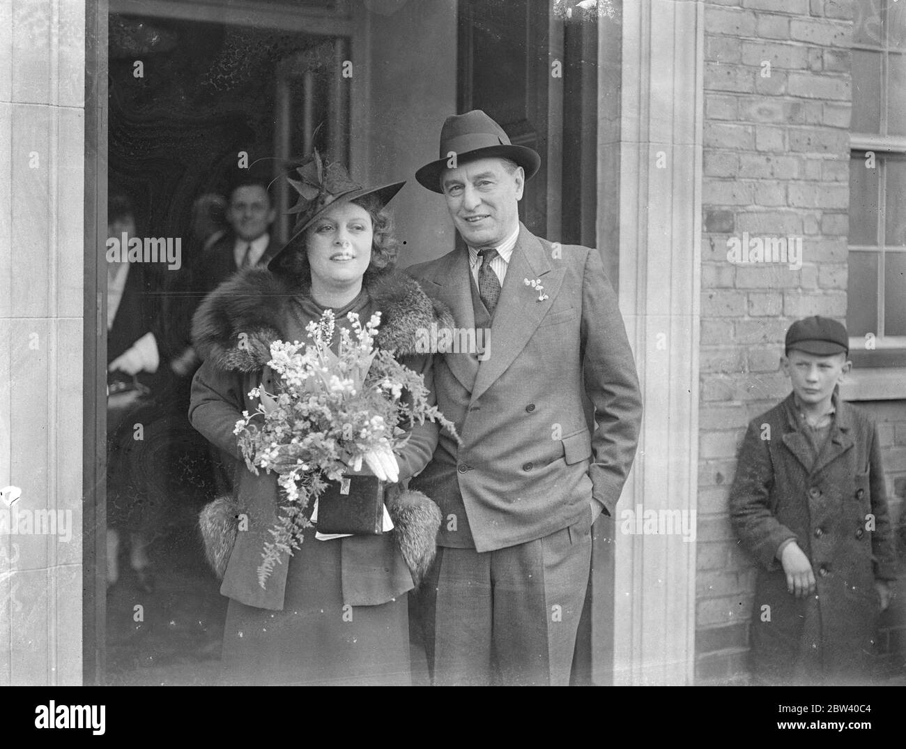 Film producer married at Edgware register office . The 10-year-old romance culminated at the Burnt Oak register office , Mill Hill , when Mr Joe Bramberger , the film producer and managing director of the £100000 Elstree Studios , was married to 35 year old Miss Adelaide Stewart . Photo shows , the bride and groom leaving the wedding . 10 April 1937 Stock Photo