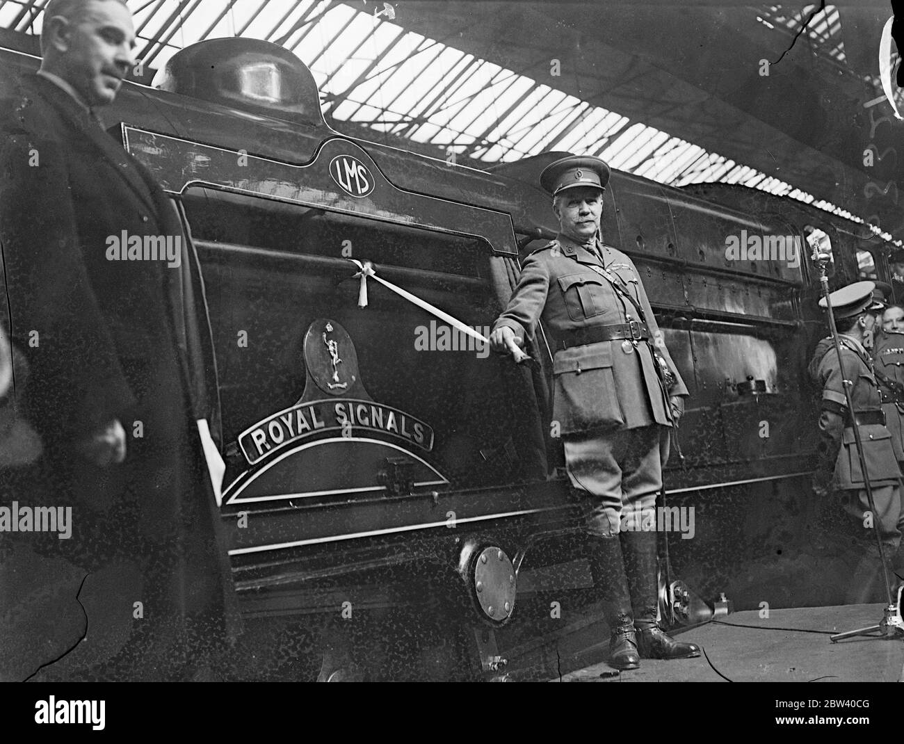 ' Royal Corps ' locomotive named by Cmdr at Euston . Saluted by a guard of honour of the London Corps Signals , Brigadier Hubert Clementi-Smith , Colonel Commandant of the Royal Corps of Signals , named one of the London Midland and Scottish Railway regimental class locomotives ' Royal Signals '' at Euston Station , London . Photo shows , Brig H Clementi Smith naming the new locomotive at Euston . 10 April 1937 Stock Photo