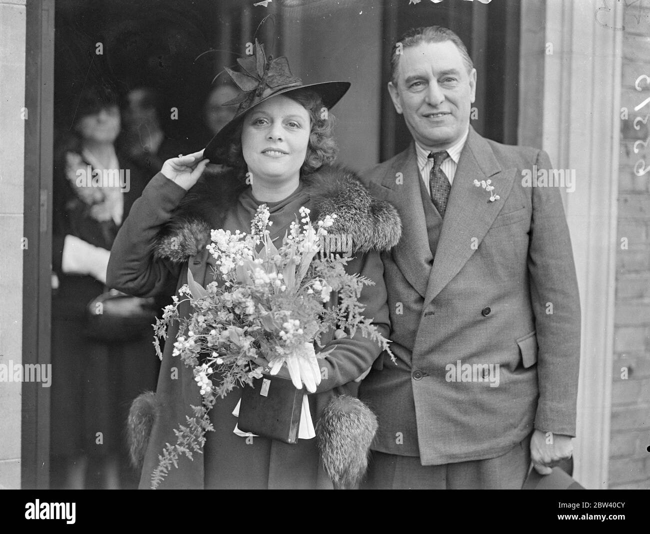 Film producer married at Edgware register office . The 10-year-old romance culminated at the Burnt Oak register office , Mill Hill , when Mr Joe Bramberger , the film producer and managing director of the £100000 Elstree Studios, was married to 35 year old Miss Adelaide Stewart . Photo shows , the bride and groom are leaving the wedding . 10 April 1937 Stock Photo