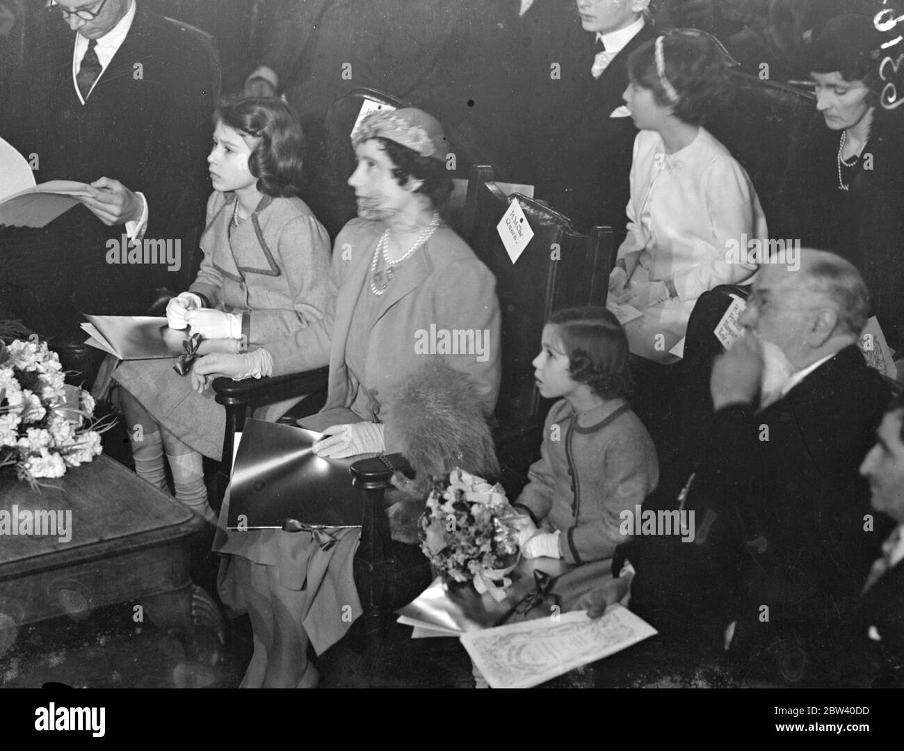 The Queen took her daughters, Princess Elizabeth and Princess Margaret Rose, to the Coronation Concert for Children at the Central Hall, Westminster. Photo shows: the Queen and Princess Elizabeth and Prince Margaret rose to the concert. 6 April 1937 Stock Photo