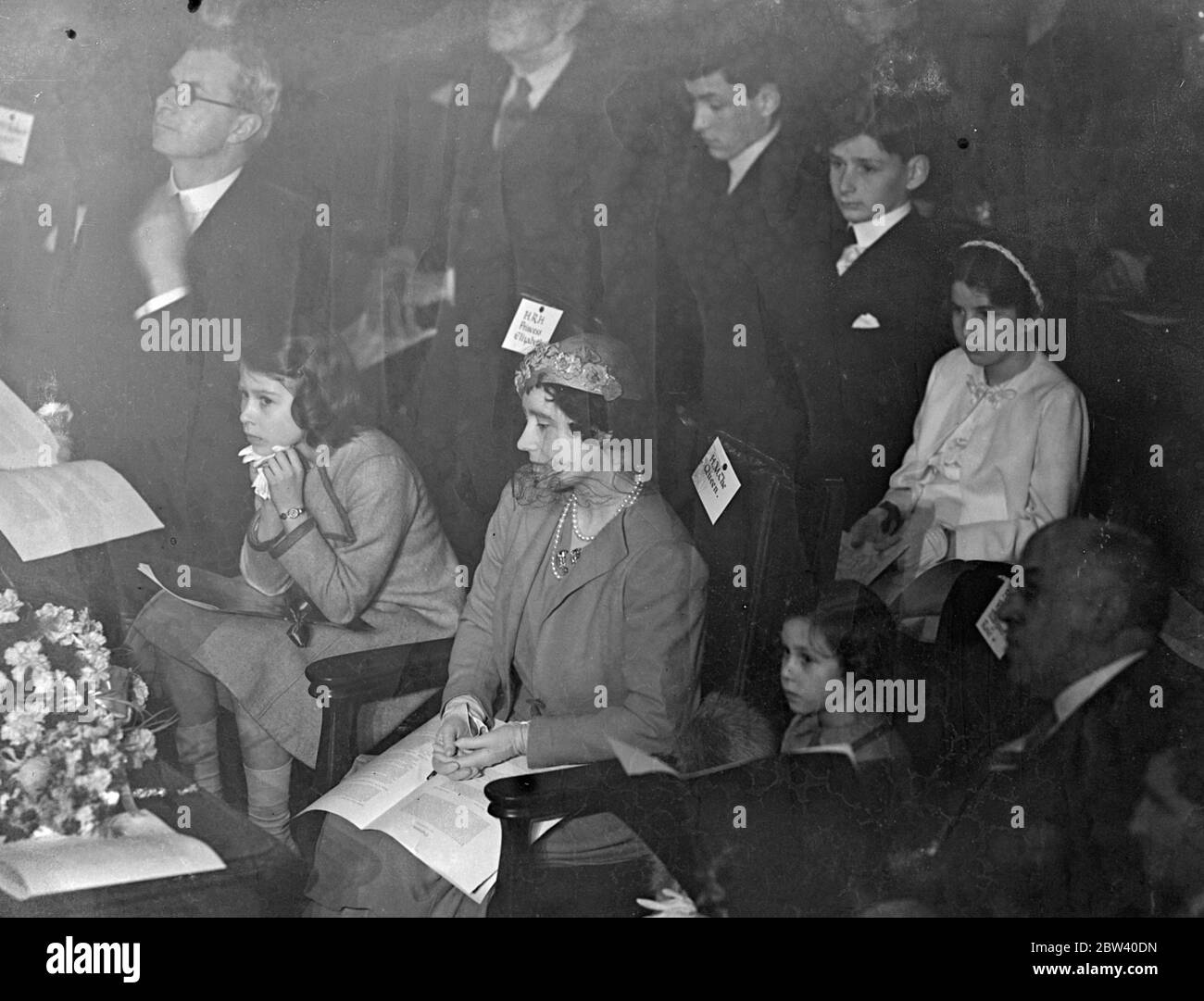 The Queen took her daughters, Princess Elizabeth and Princess Margaret Rose, to the Coronation Concert for Children at the Central Hall, Westminster. Photo shows: the Queen and Princess Elizabeth and Prince Margaret rose to the concert. 6 April 1937 Stock Photo