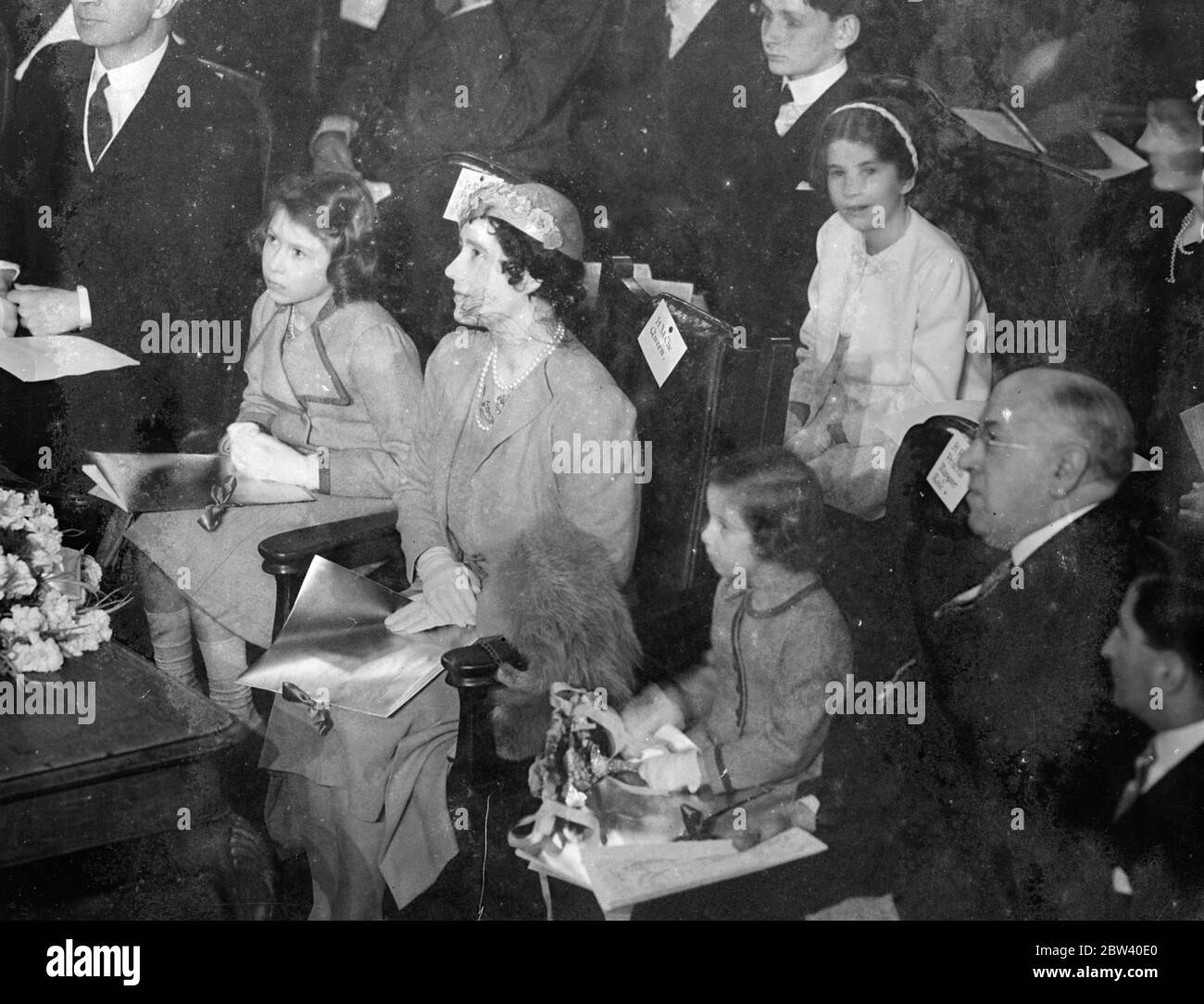 The Queen took her daughters, Princess Elizabeth and Princess Margaret Rose, to the Coronation Concert for Children at the Central Hall, Westminster. Photo shows: An expression of Princess Elizabeth as she listens to the concert. 6 April 1937 Stock Photo