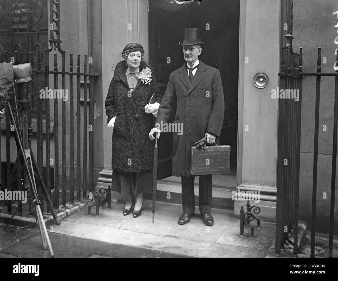 Mr Chamberlain leaves Downing Street to make budget speech. Mr Neville Chamberlain, the Chancellor of the Exchequer, let number 11 Downing Street to make his budget speech in the House of Commons. Photo shows: Mr Neville Chamberlain leaving Downing Street accompanied by his wife with his secrets securely locked in the Budget Case. 20 April 1937 Stock Photo