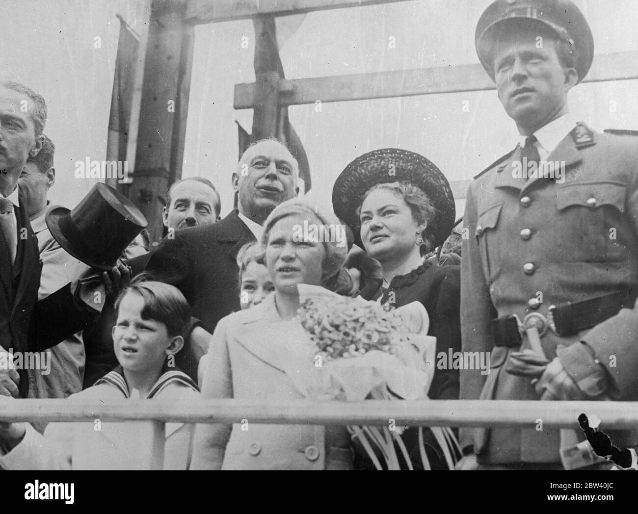 Royals children watch as King Leopold launches two ships. King Leopold of the Belgians, accompanied by two of his children - Crown Prince Baudoin and Princess Josephine Charlotte, lunched two ships at Hoboken, Antwerp. The vessels were the Moandar freighter, and Prince Baudoin, a mail steamer. Photo shows: King Leopold (right), Crown Prince Baudoin (left, sailor suit) and Princess Josephine Charlotte (centre) watching as the Prince Baudoin took to water. 24 April 1937 Stock Photo