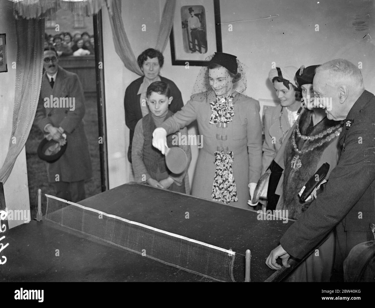 Duchess of Gloucester plays table tennis after opening new east and flats. After opening the new flats built at Prince Regent Lane, Custom House [ Newham ], for rehousing families from slum clearance and overcrowded areas, the Duchess of Gloucester unveiled a commemorative plaque and played table tennis with some of the residents. Photo shows: the Duchess of Gloucester playing table tennis at the flats. 7 April 1937 Stock Photo
