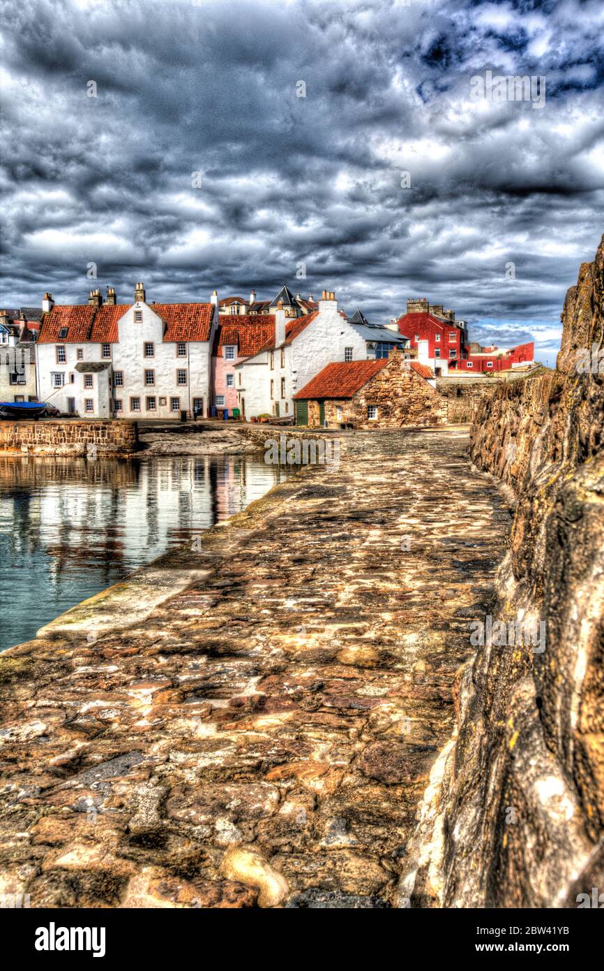 Village of Pittenweem, Scotland. The southern breakwater of Pittenweem Harbour, with harbour houses at Gyles in the background. Stock Photo