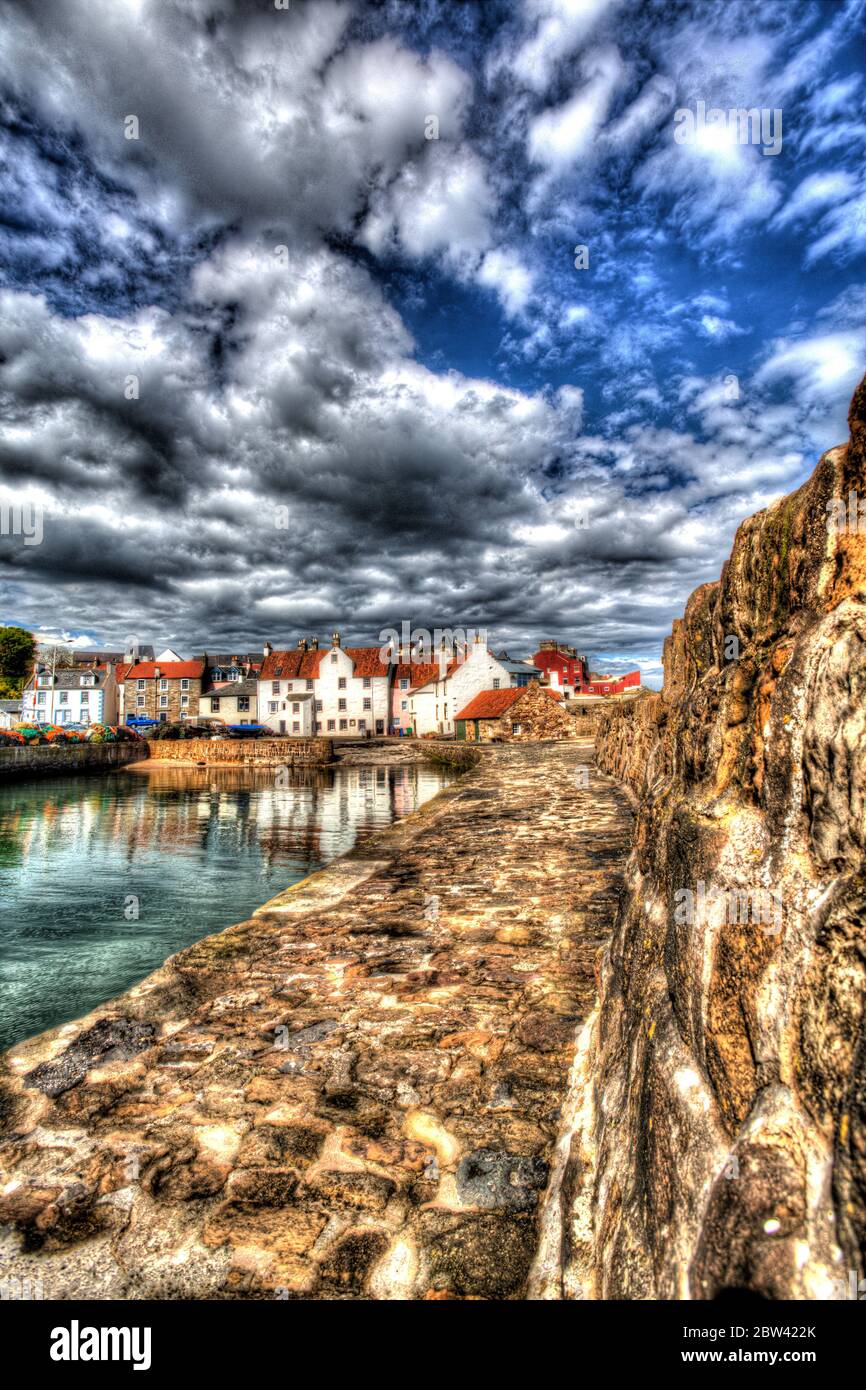 Village of Pittenweem, Scotland. The southern breakwater of Pittenweem Harbour, with harbour houses at Gyles in the background. Stock Photo