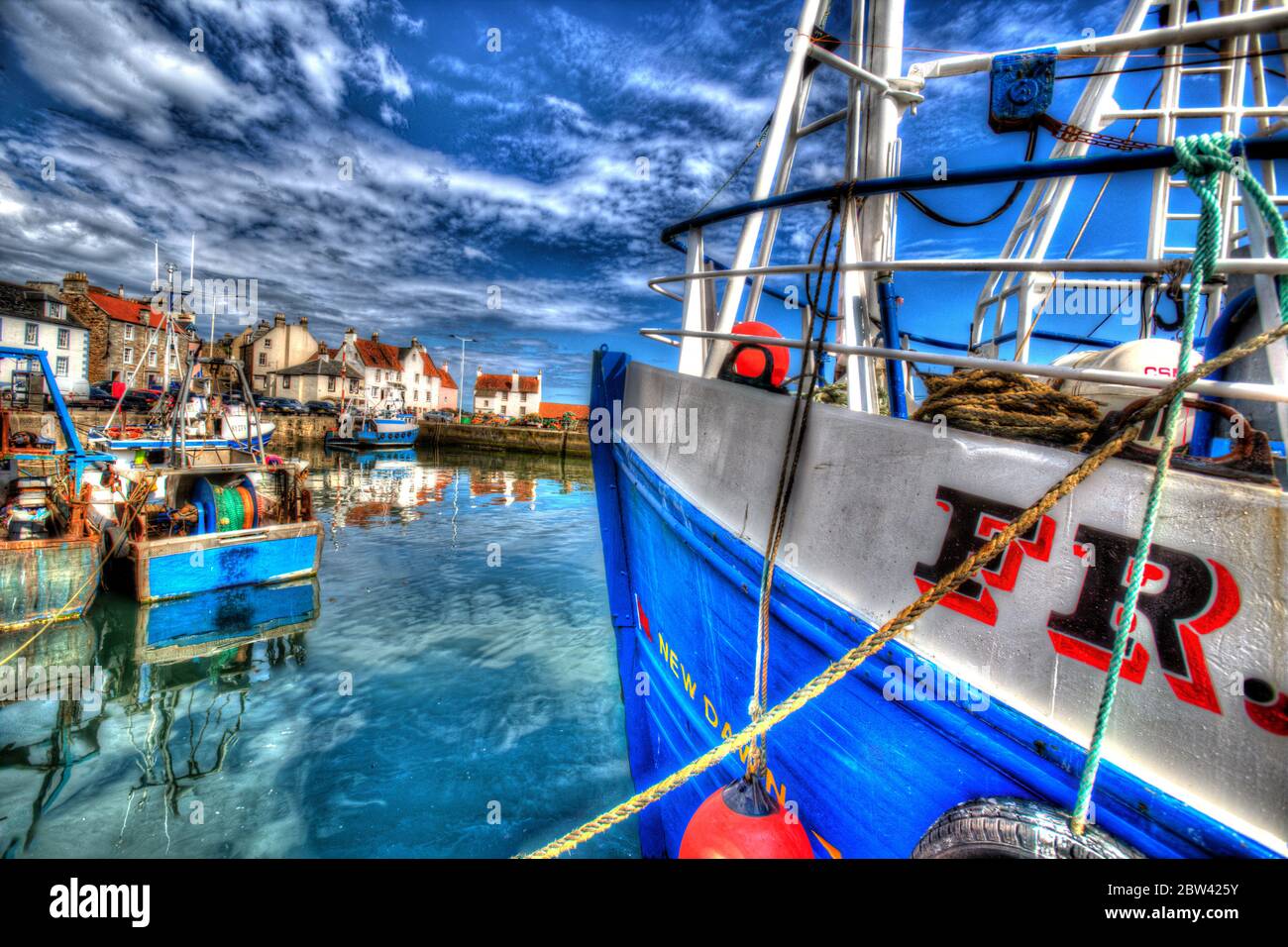 Village of Pittenweem, Scotland. Artistic view of Pittenweem Harbour, with fishing boats moored in the foreground. Stock Photo