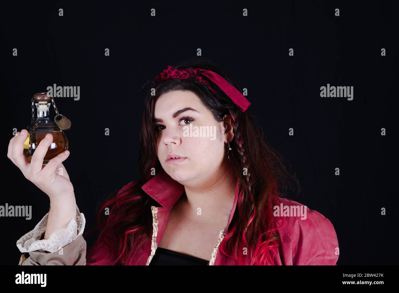 pirate girl with red jacket on the black background Stock Photo - Alamy