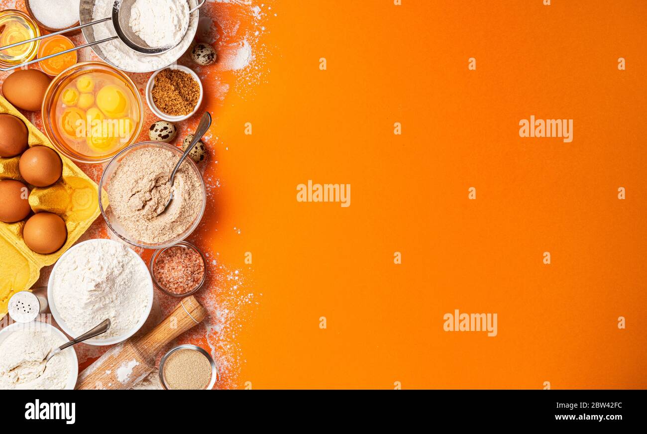 Baking ingredients on yellow color background, top view Stock Photo