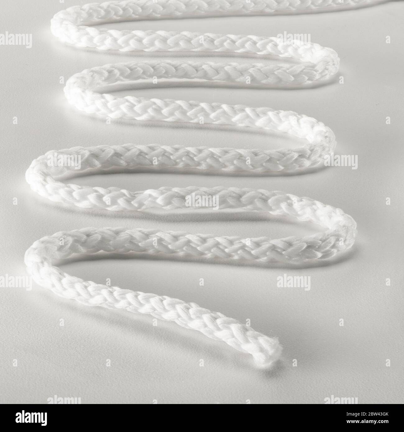 White string placed in serpentine pattern Stock Photo