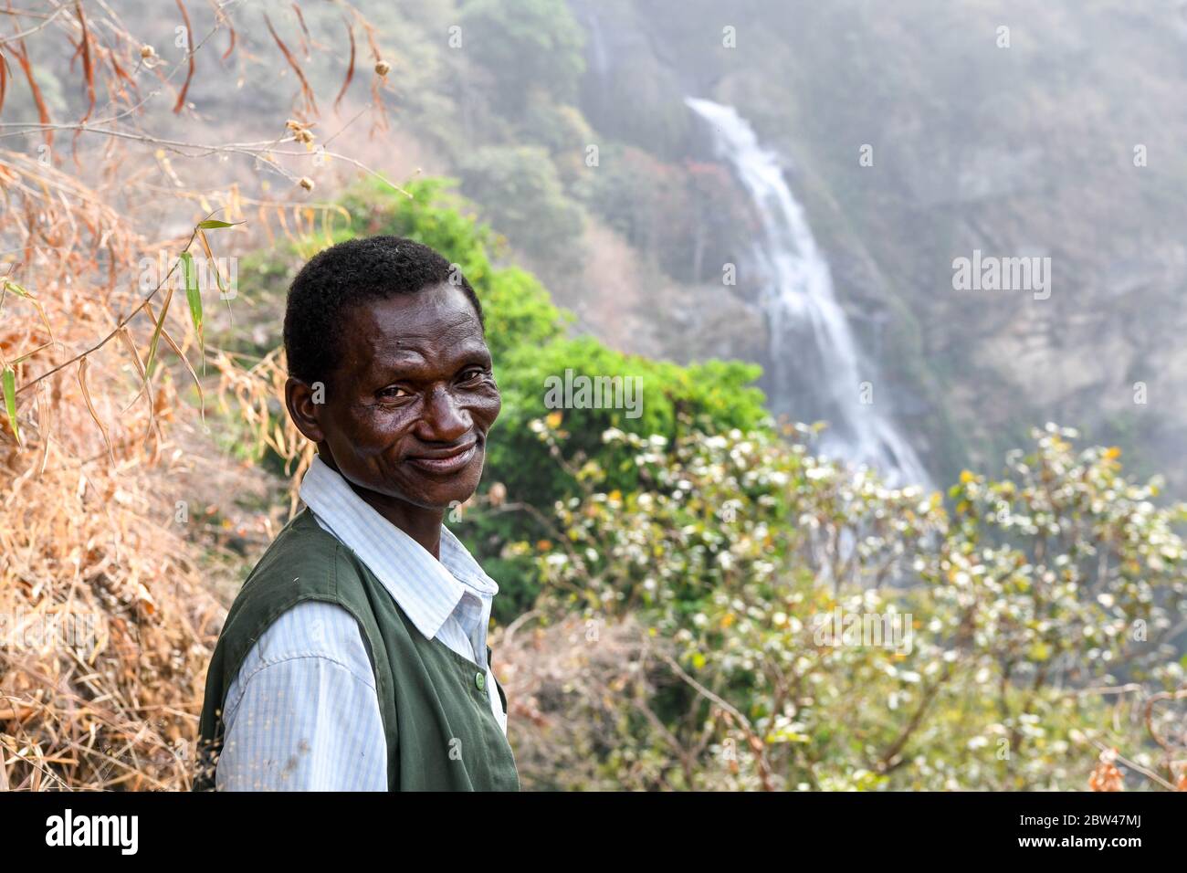 Africa, West Africa, Ghana, Wli Falls. The guide leads the way through the jungle to the Wli Falls in the middle of the mountain. Stock Photo