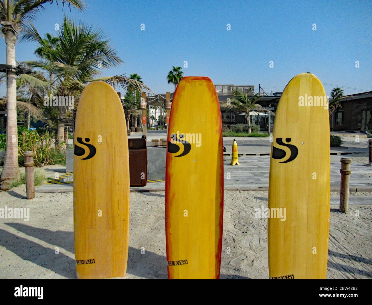 Three surfboards on the beach in the sun in Dubai Stock Photo Alamy