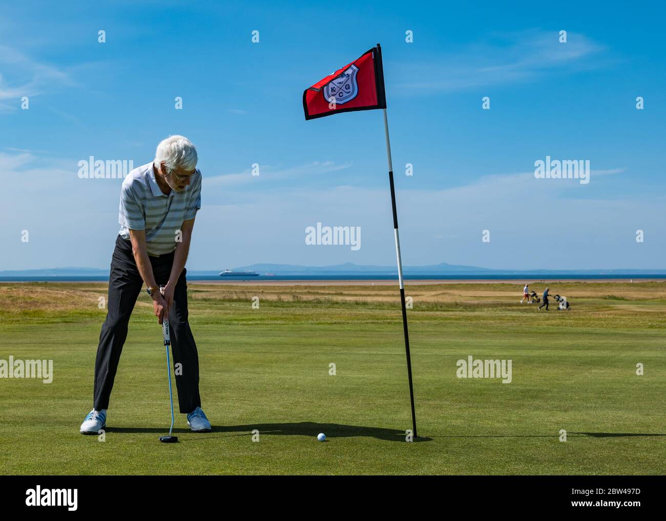 Man playing golf on putting green, Golf Club reopening, Kilspindie golf course, Aberlady, Scotland, UK Stock Photo