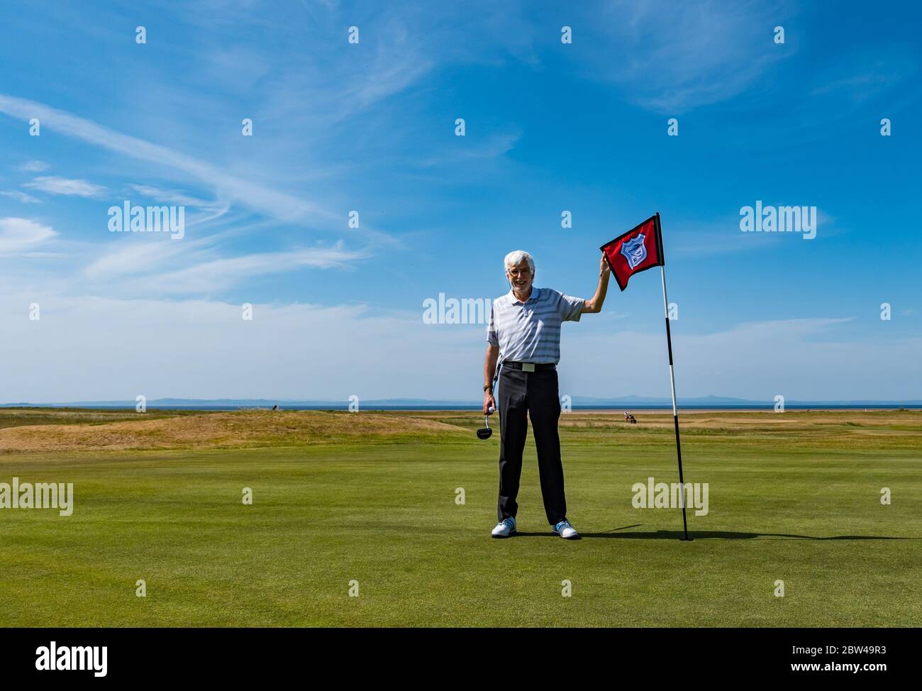 Man playing golf on putting green, Golf Club reopening, Kilspindie golf course, Aberlady, Scotland, UK Stock Photo