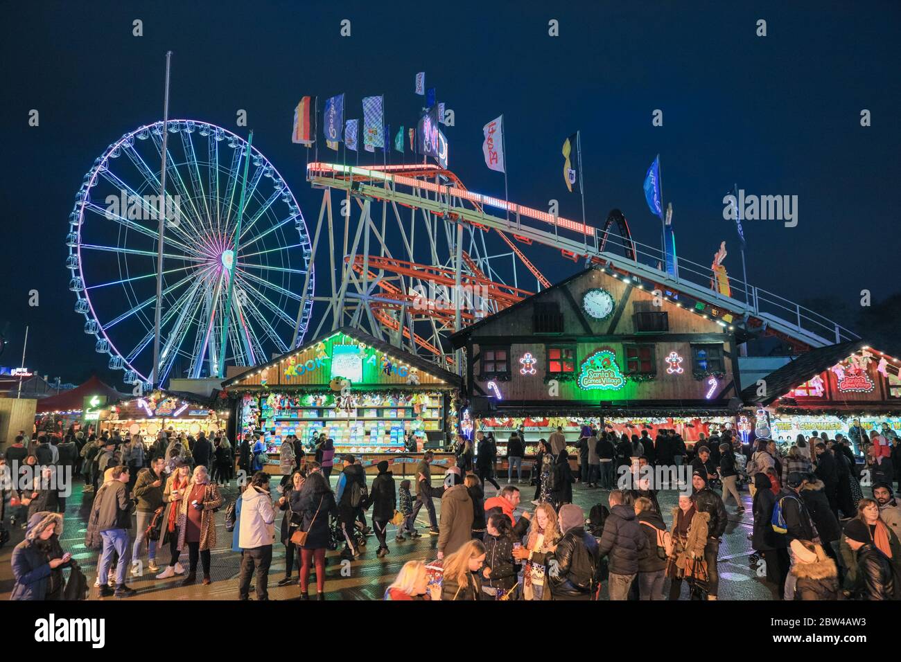Crowds at food stalls and funfair rides, Winter Wonderland, Hyde Park