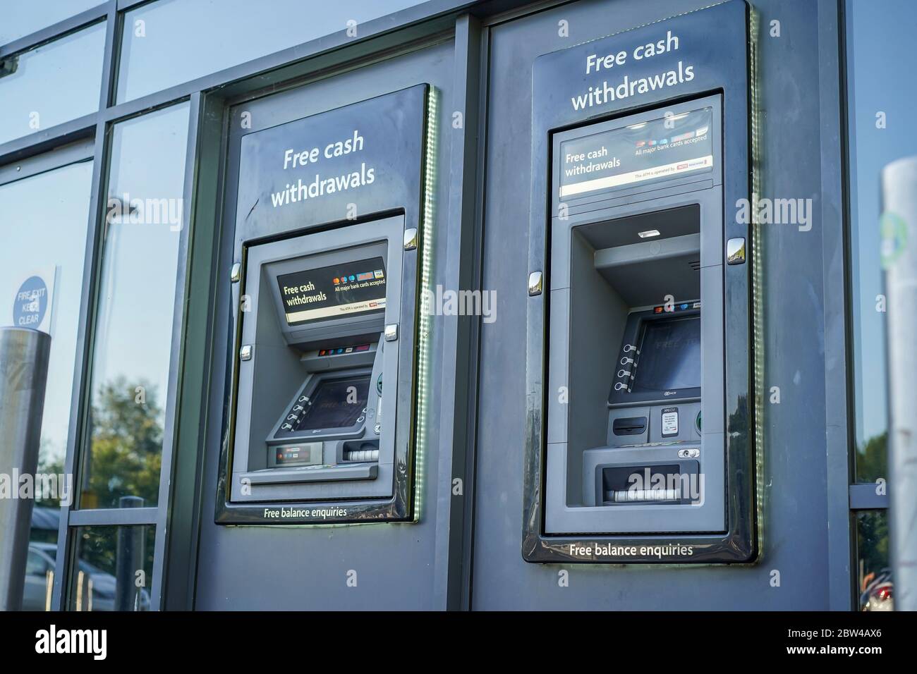 Close up ATM machines isolated outside UK supermarket. British outdoor cashpoint machine. 'Hole in the wall' cash withdrawals. Public ATMs. Stock Photo