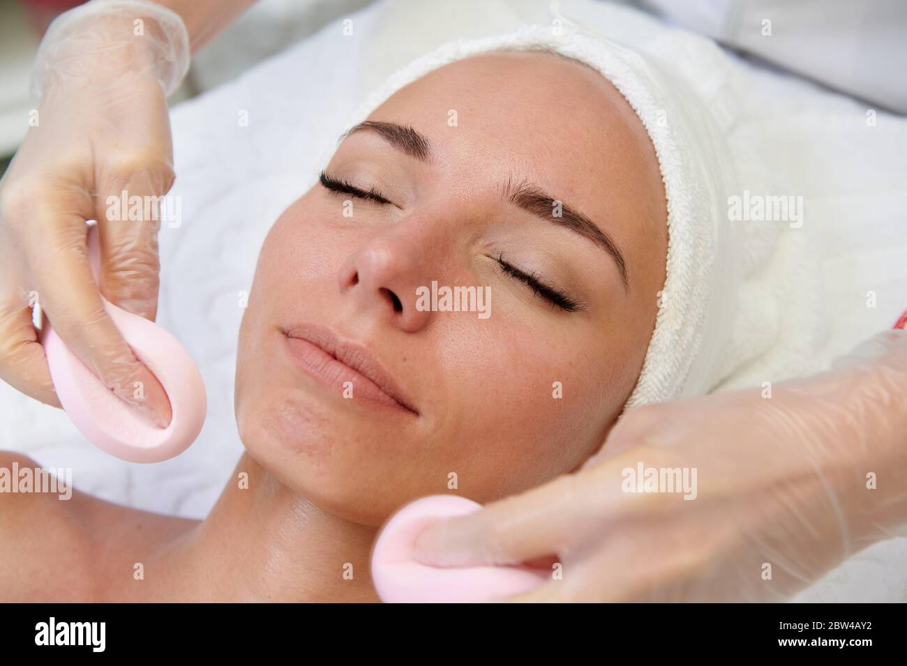 Female getting facial massage alternative medicine top view Stock Photo