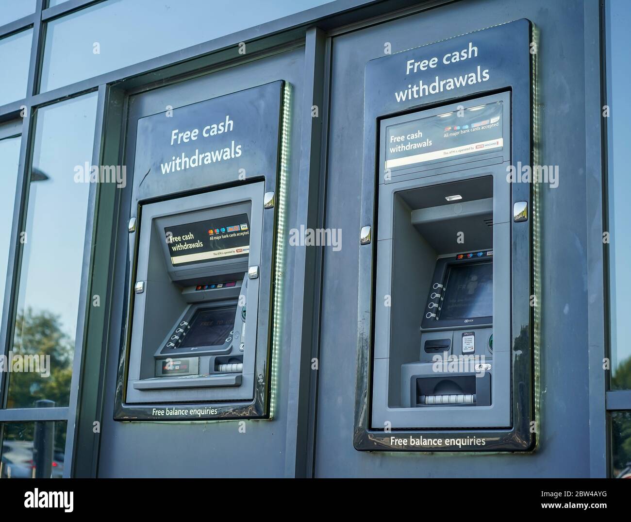 Close up ATM machines isolated outside UK supermarket. British outdoor cashpoint machine. 'Hole in the wall' cash withdrawals. Public ATMs. Stock Photo