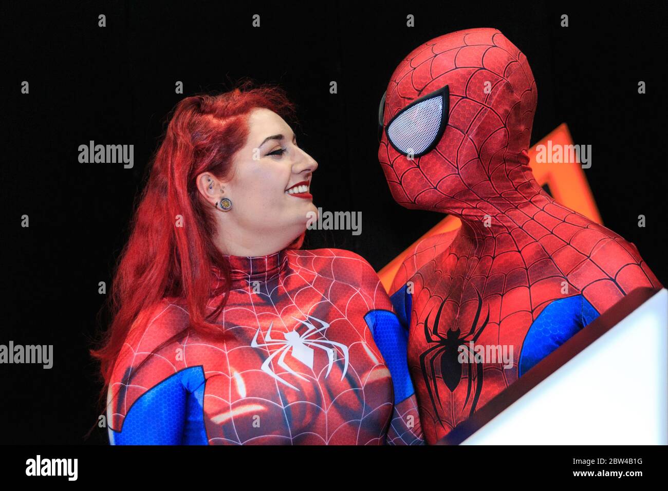 Spiderman and Spiderwoman pose togetherat MCM Comicon cosplayer convention, ExCel London, UK Stock Photo